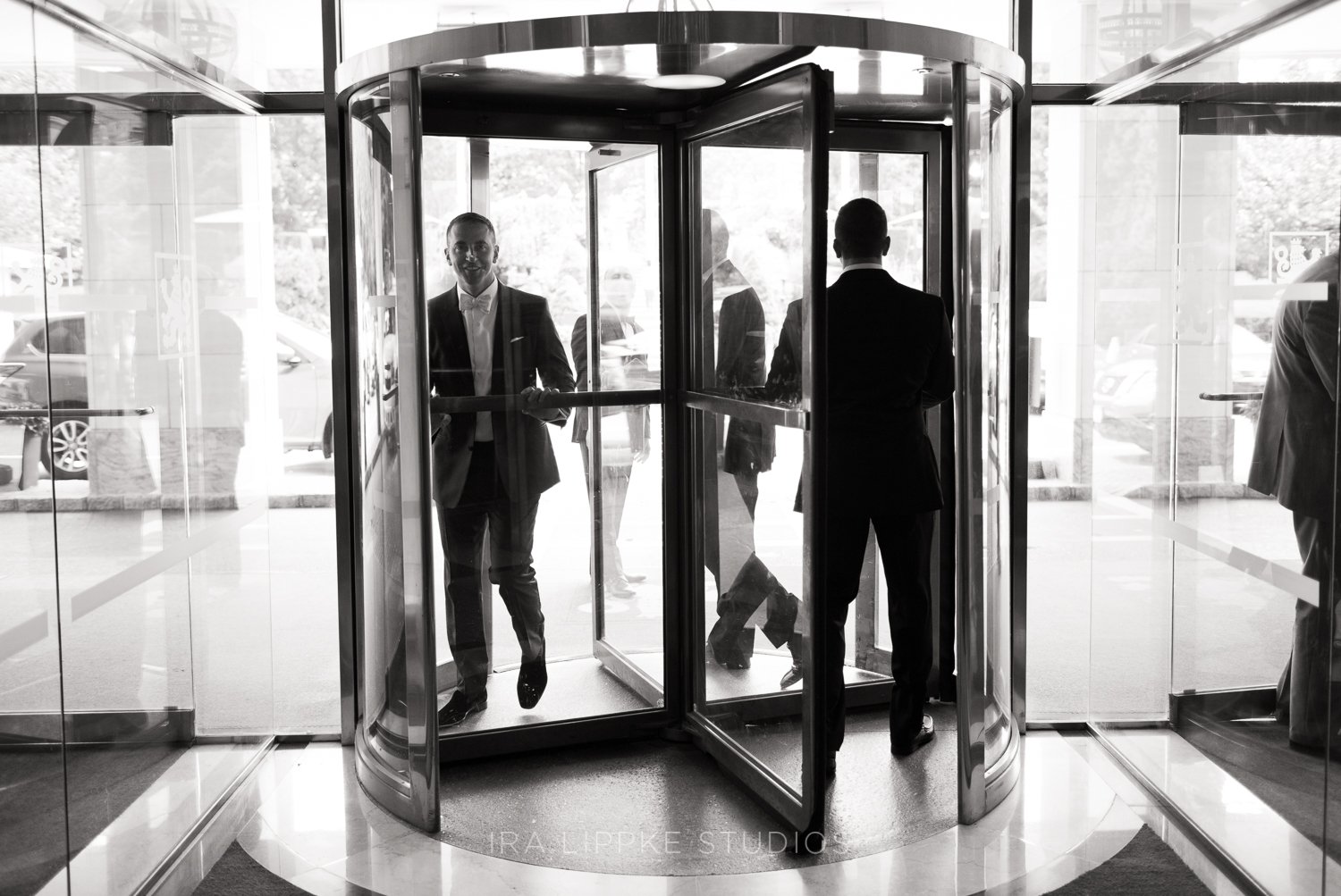 Members of the wedding party make their way through the iconic revolving doors of the Garden City Hotel as the day’s festivities begin.
