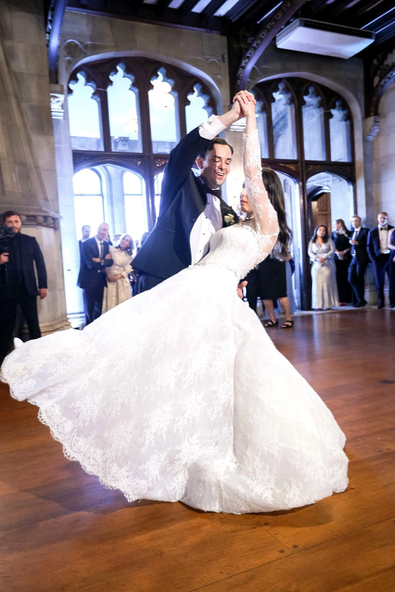 Bride and groom first dance inside Hempstead House ballroom with flowing wedding gown
