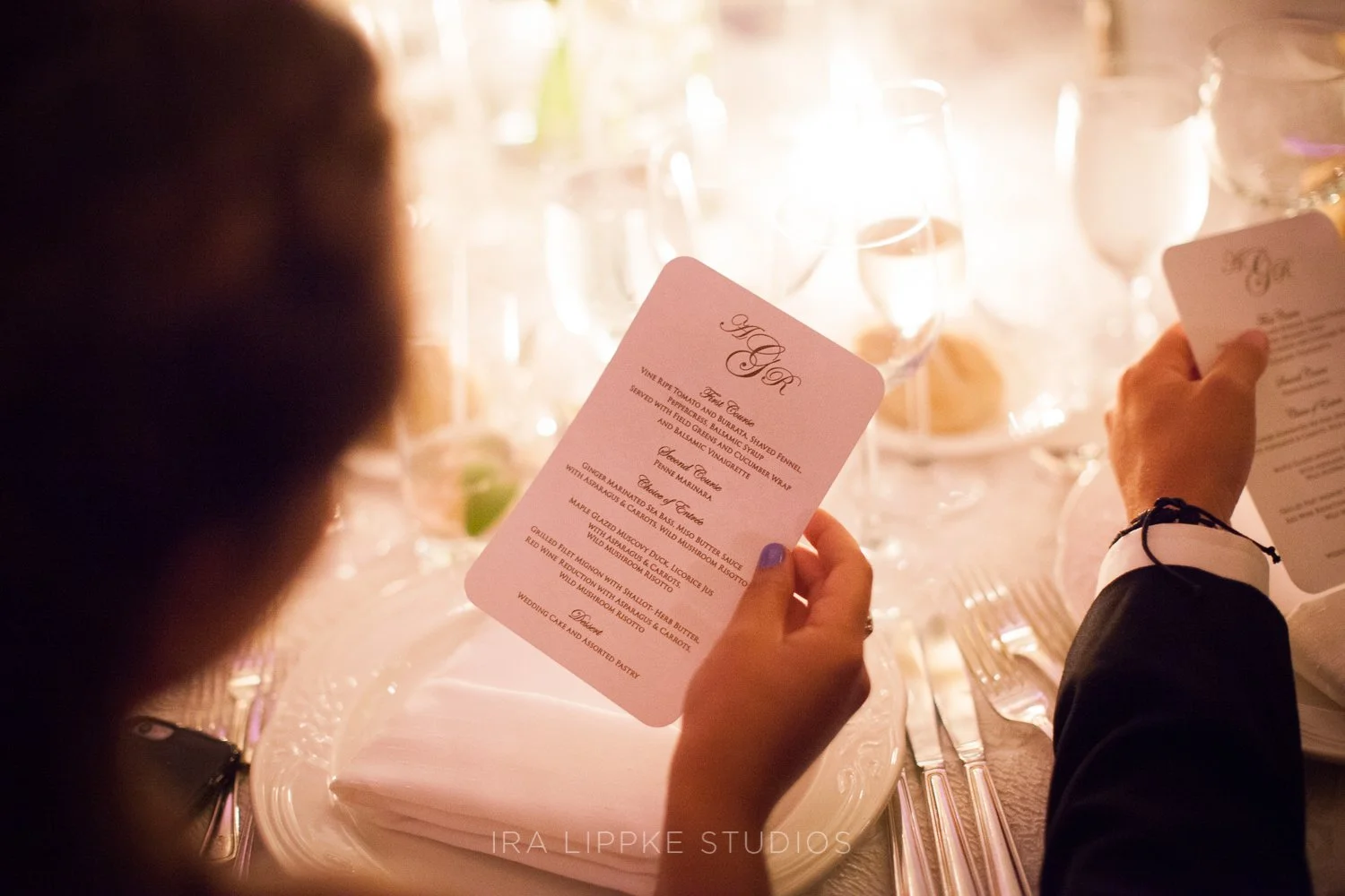 A guest reviews the evening’s menu, highlighting the thoughtful details and elevated dining experience planned for the celebration.