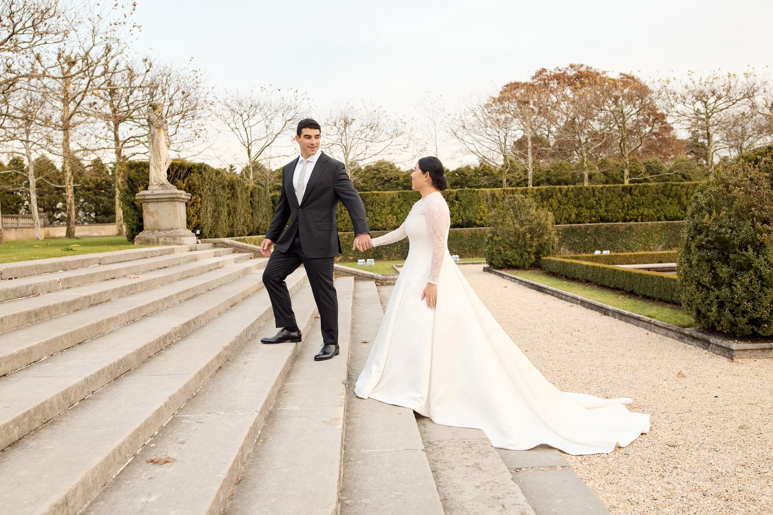 A timeless estate setting providing a natural backdrop for an elegant and effortless portrait of the Bride and Groom on the rear stairs of Oheka Castle.