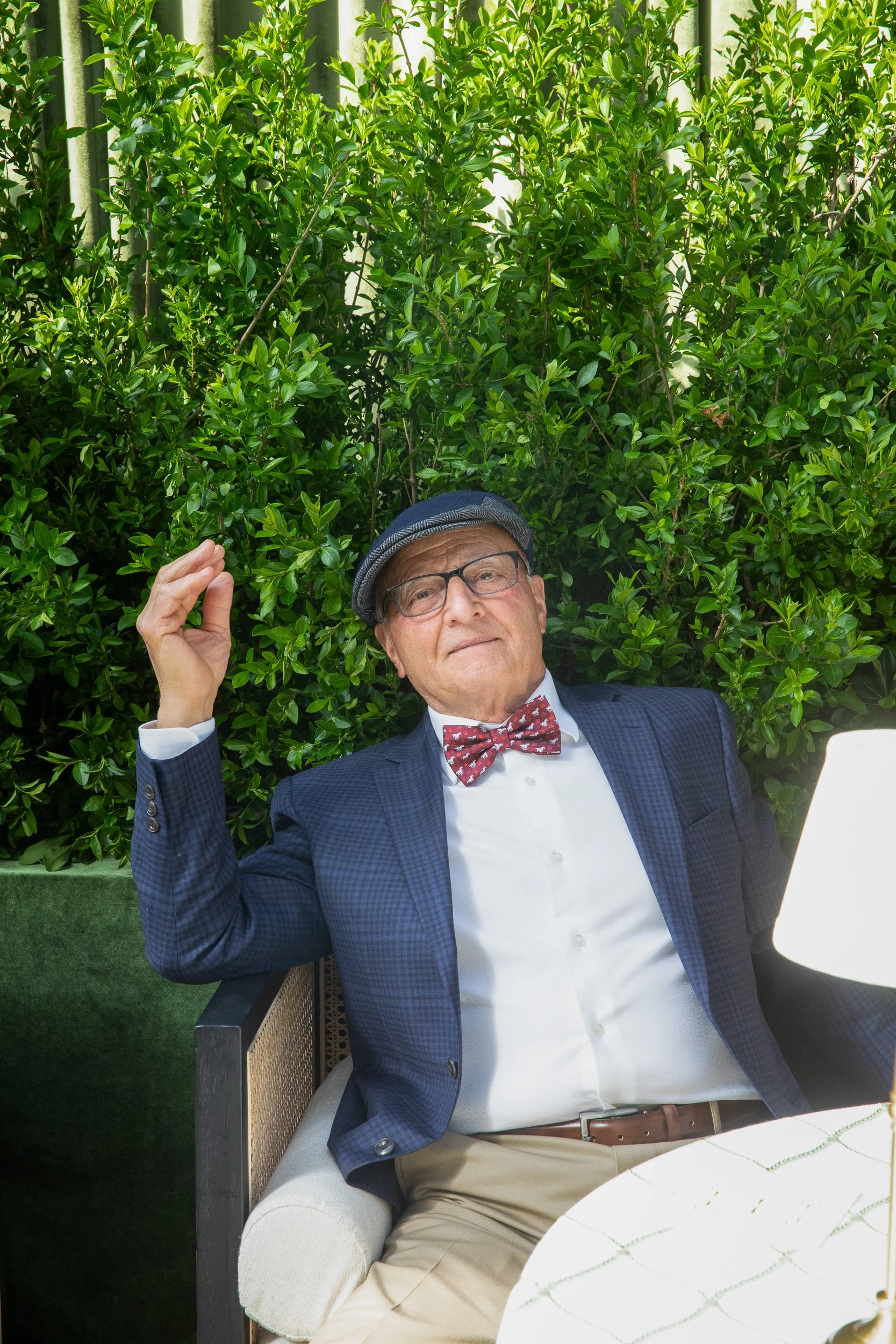 A stylish guest relaxing beneath the tented lounge environment during the private Kentucky Derby celebration in Lloyd Harbor.