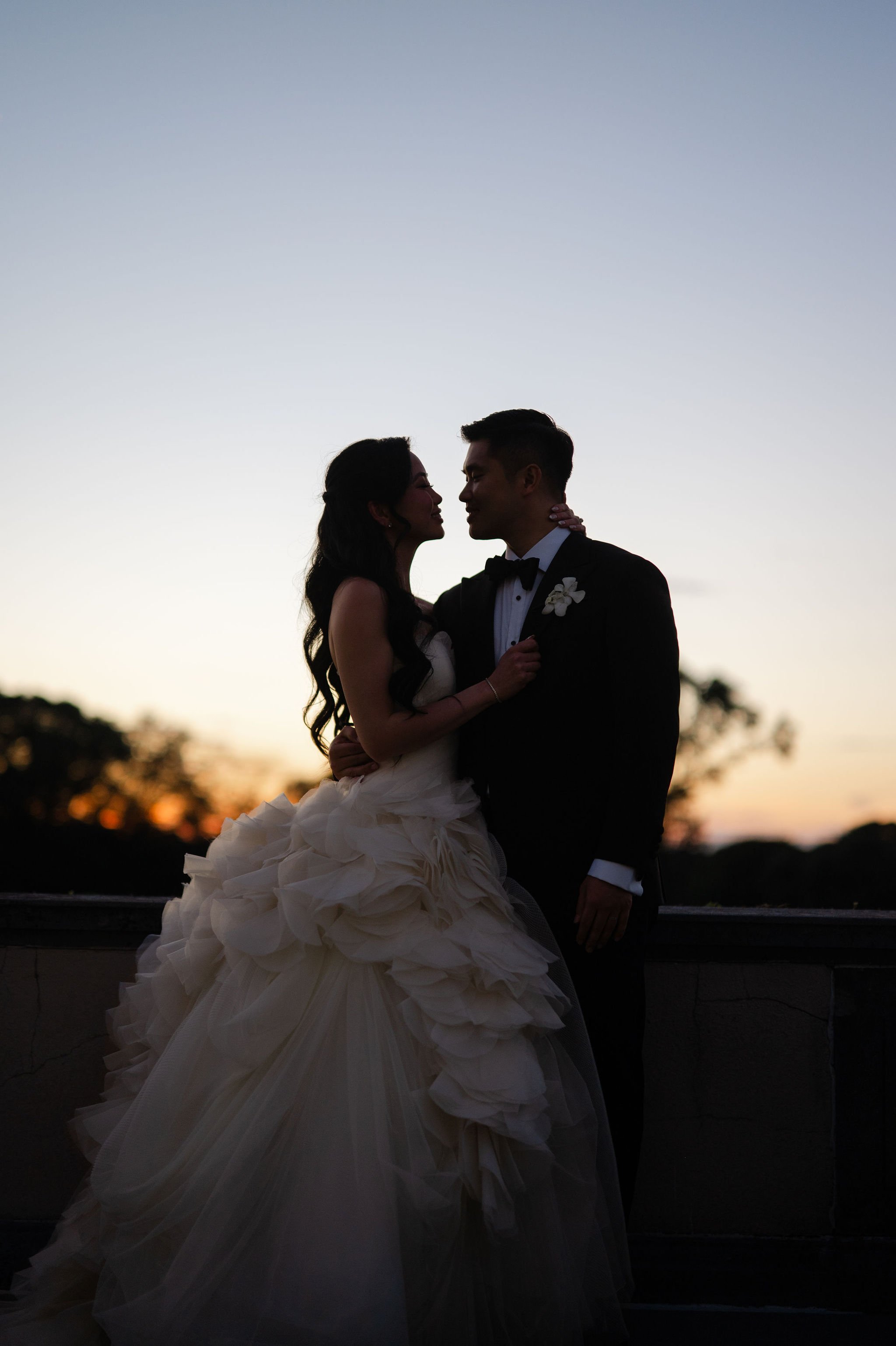 As the sun set over Oheka Castle, Erica and Ben slipped into a quiet moment together, silhouetted against the fading light. It was a soft, romantic close to an evening defined by beauty, movement, and intention.