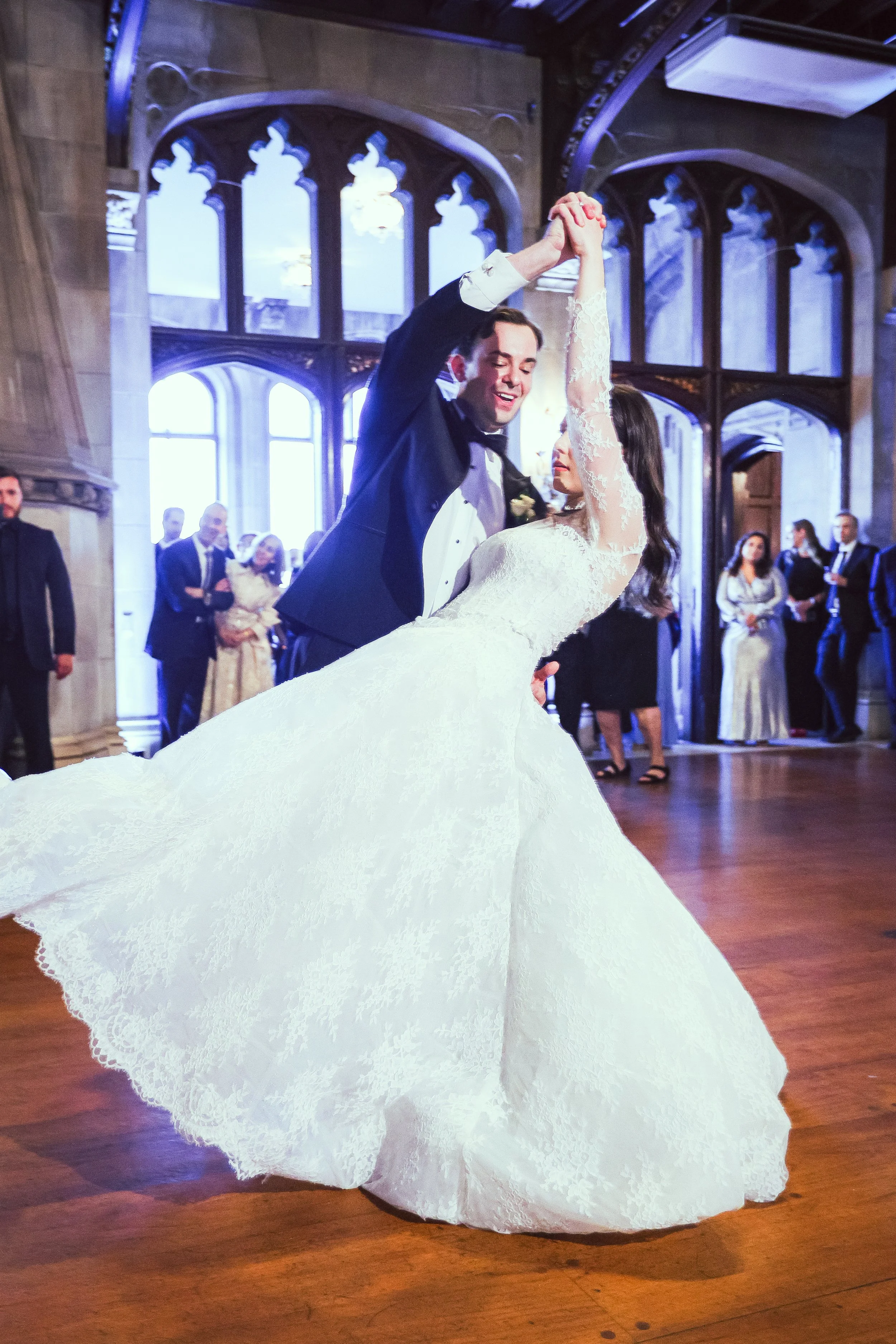 Bride and groom first dance inside Hempstead House ballroom with flowing wedding gown