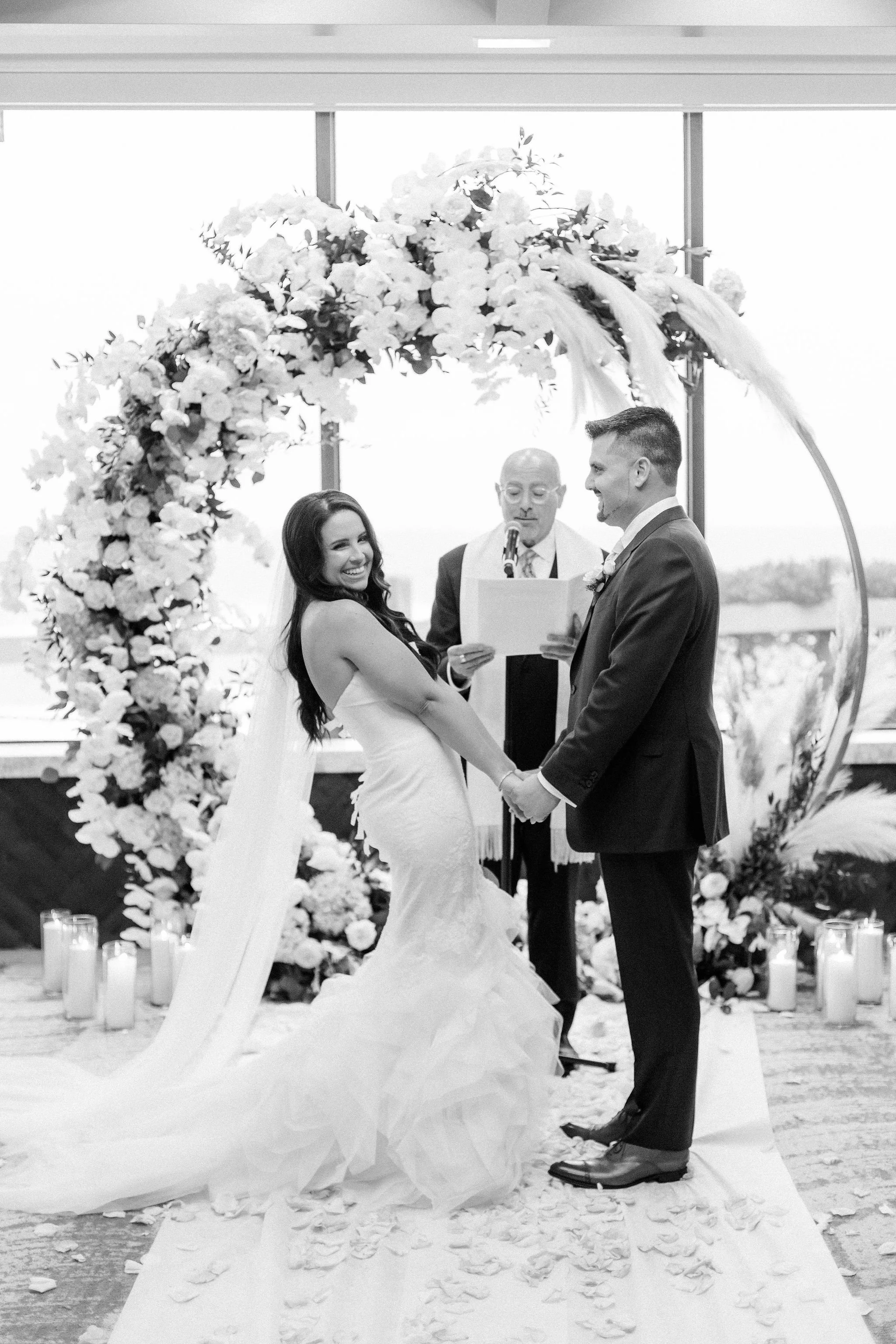 A fleeting glance, a shared smile—this was the heart of the day. Set beneath a garden of soft blooms, Ryann and Joe’s ceremony felt deeply personal, effortlessly blending elegance with genuine emotion.