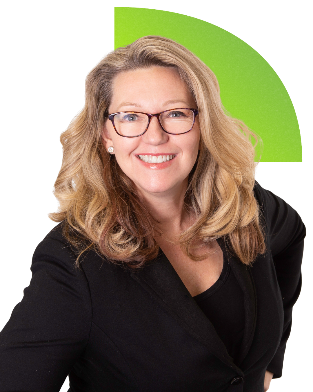 A woman with blonde wavy hair, glasses, and earrings smiling, wearing a black blazer against a green background.
