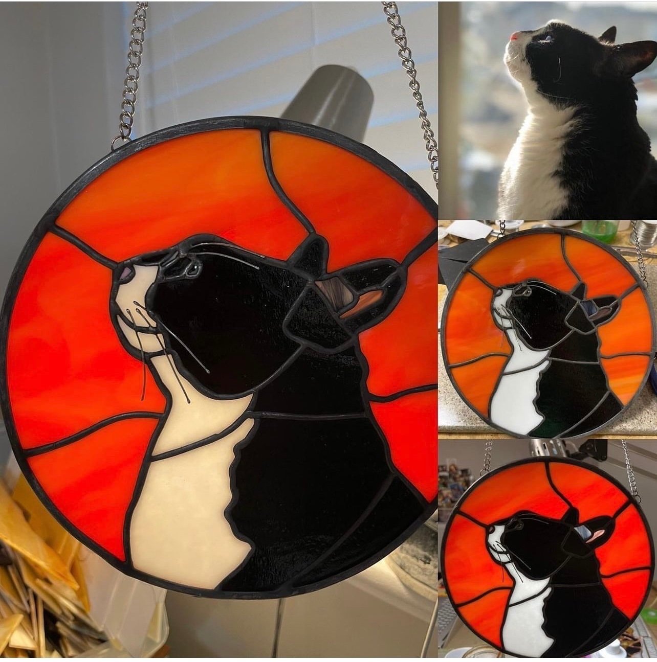 Stained glass lamp featuring a black and white cat's head against a red and orange background.
