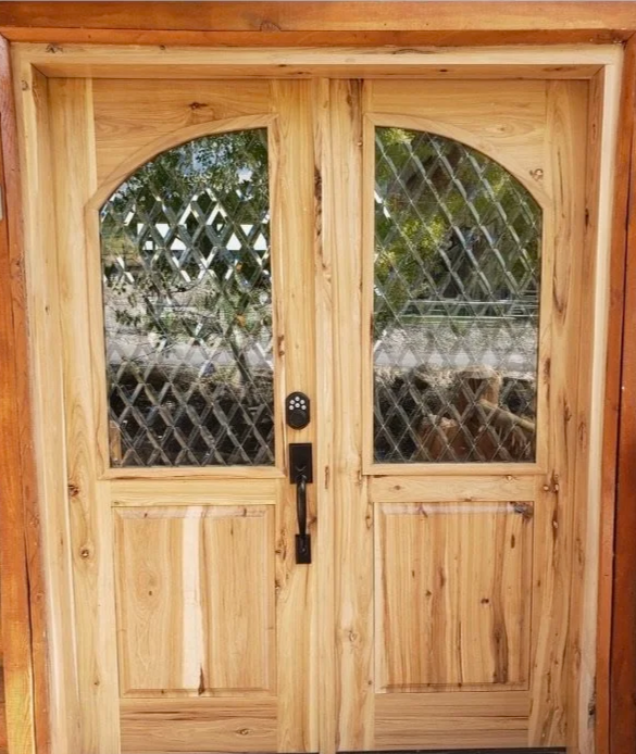 Wooden double door with diamond-patterned glass windows