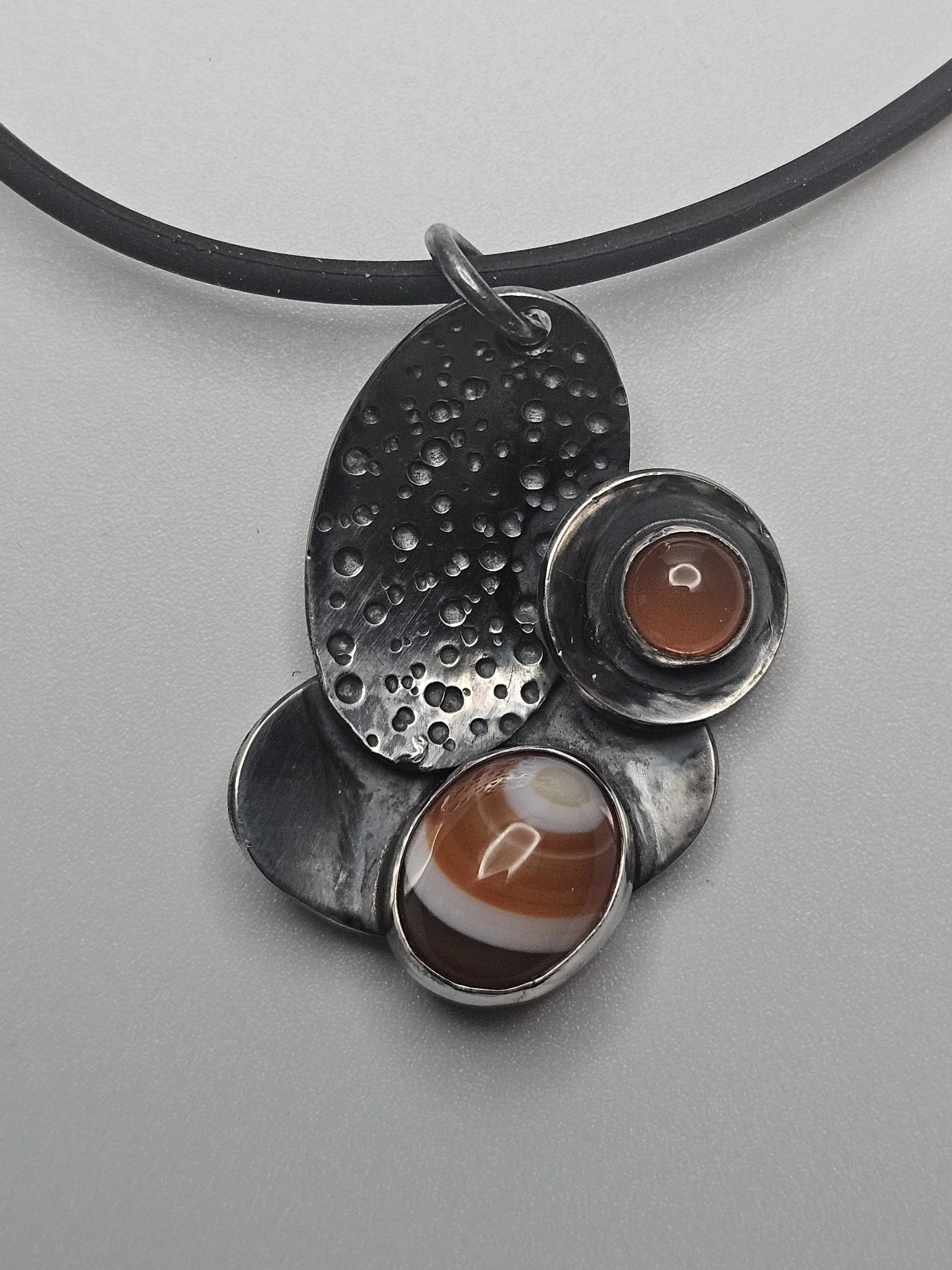 Pendant with Curves and Orange Stones