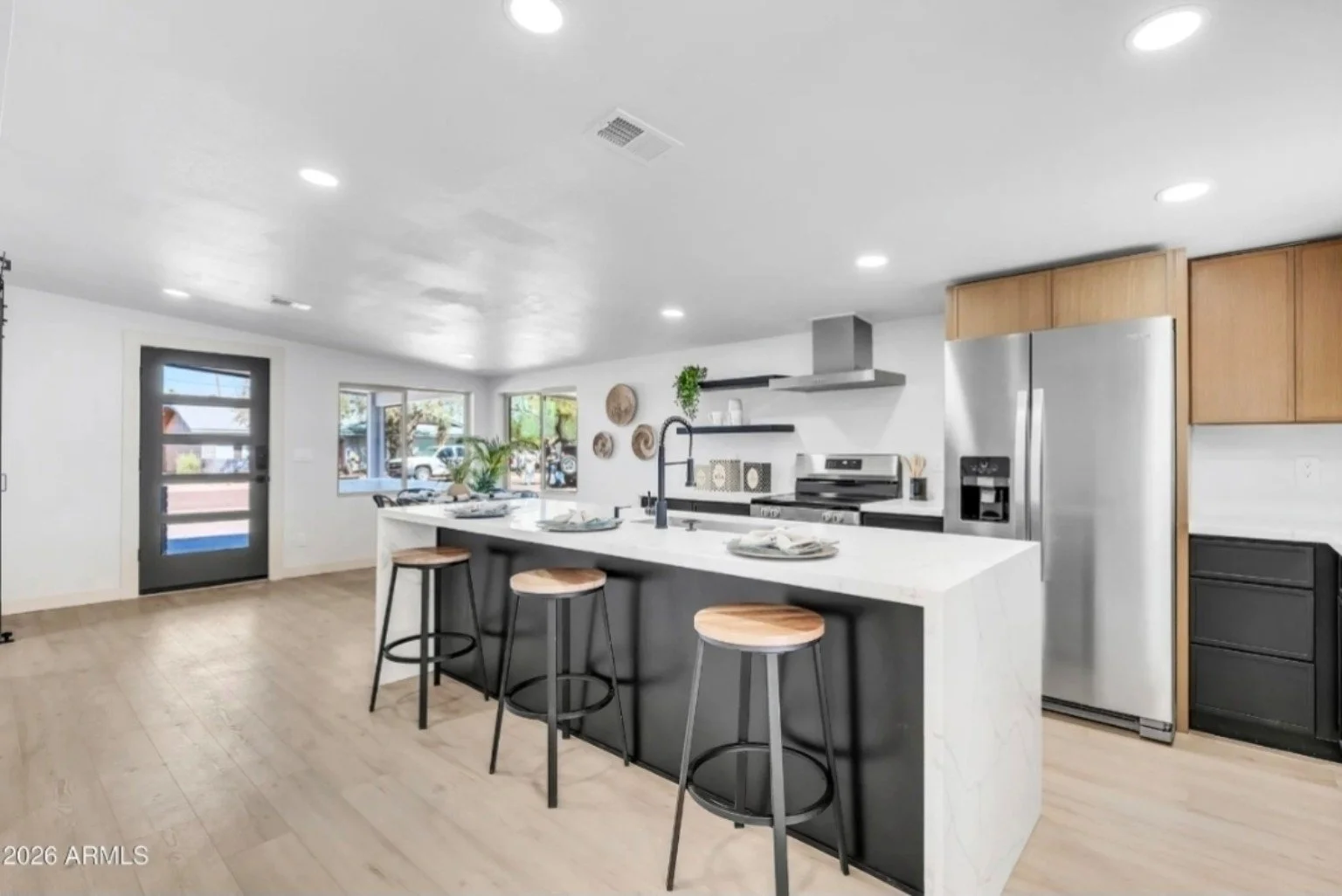 Kitchen remodeling project in Arizona featuring a large island, modern cabinetry, stainless steel appliances, and updated finishes.