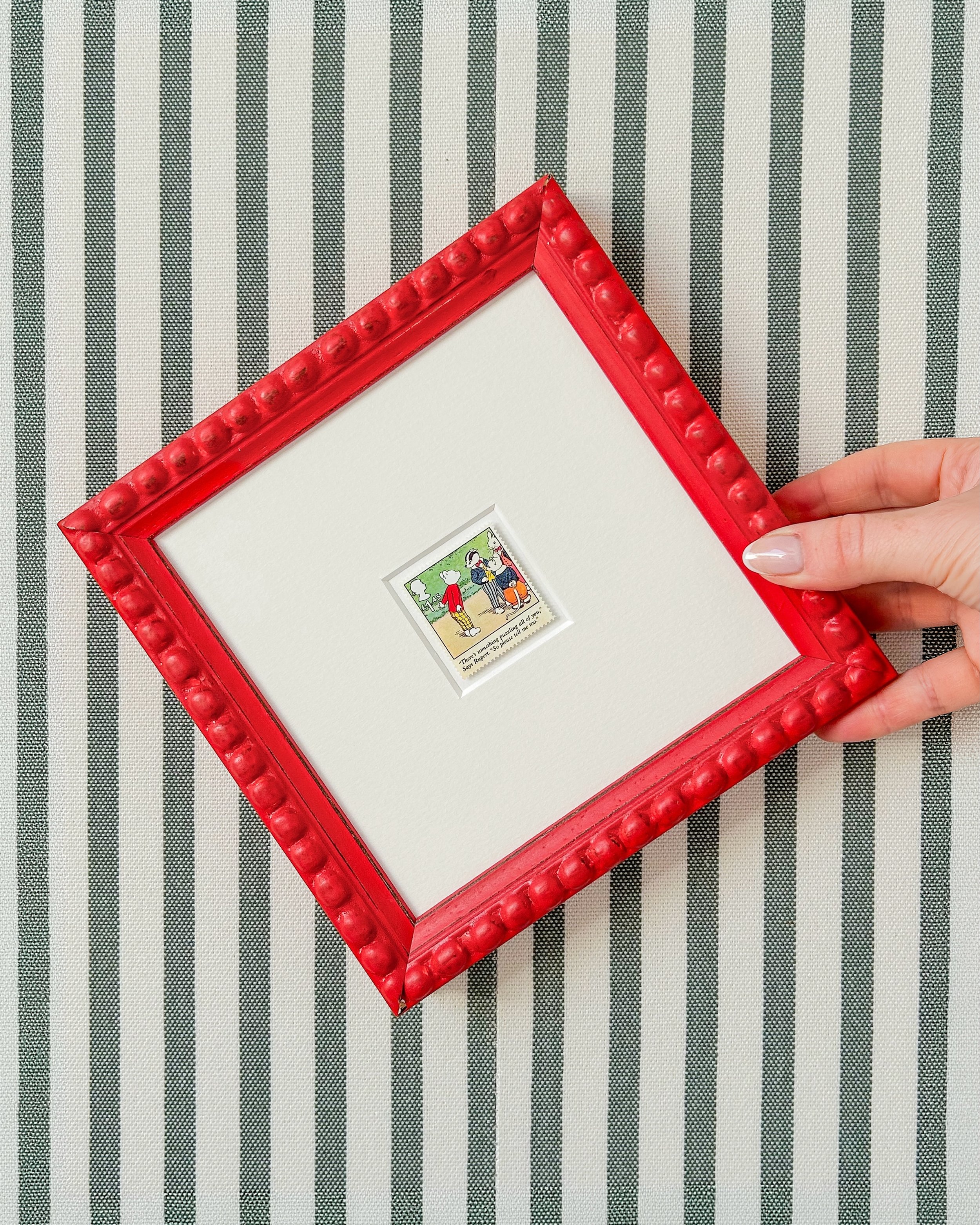 Rupert Bear in a red frame, one of a matched pair. Sold together, so both sides of the story sit on the wall side by side. The red would work perfectly on a nursery wall or anywhere a small pop of colour is welcome.

#wallart #homedecor #giftideas #n