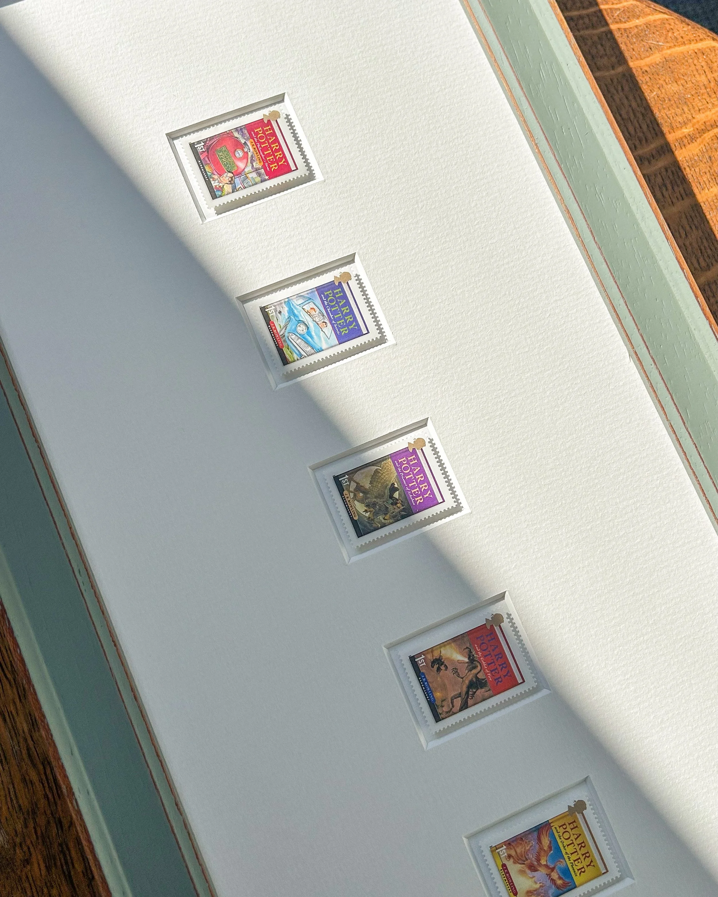 Seven stamps, one for each of the Harry Potter book covers, set in an ivory mount within a handmade distressed blue wood frame. It would suit a reading corner, a study wall or a child&rsquo;s room. Two available. Link in bio.

#wallart #homedecor #gi