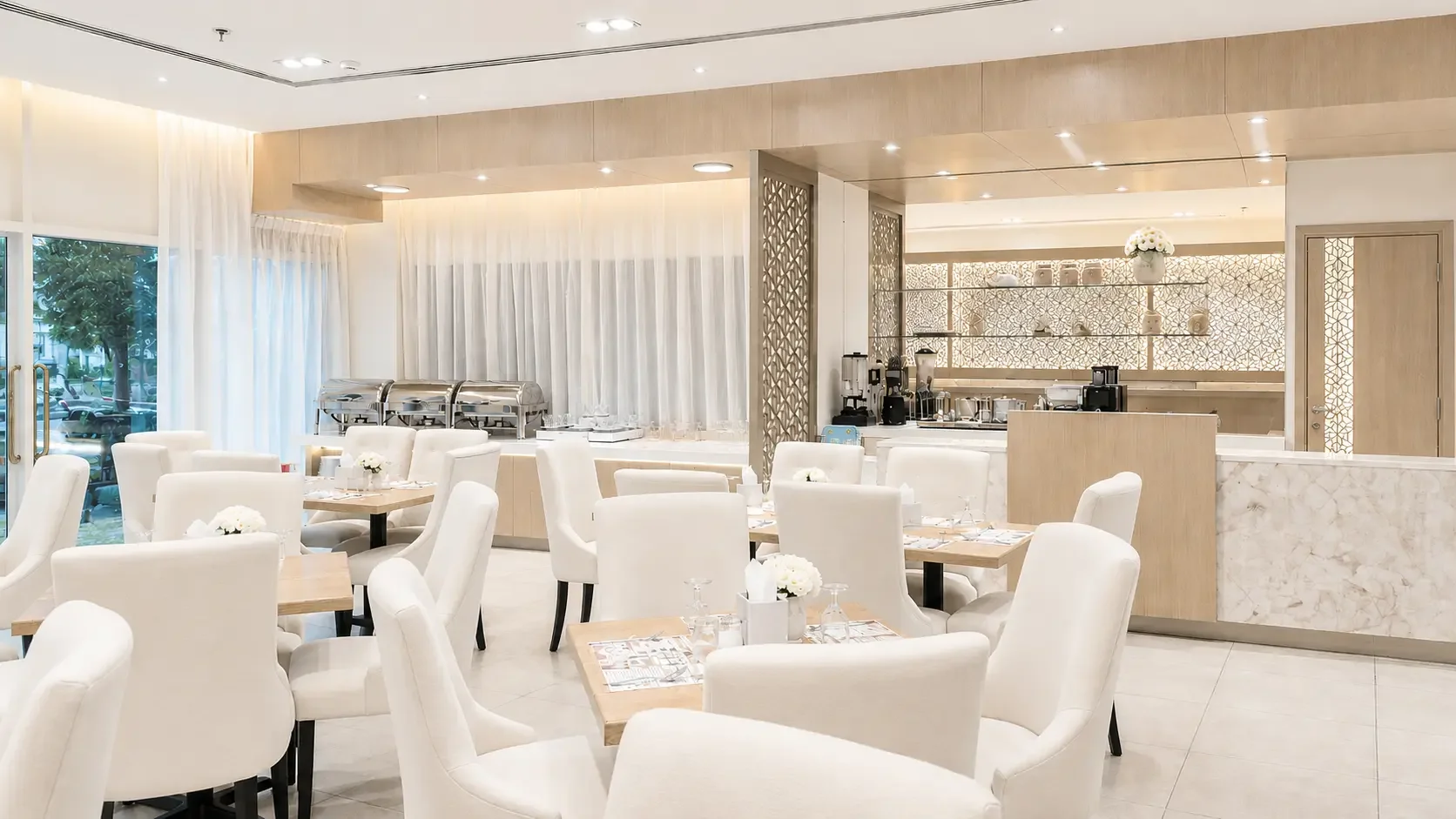 Renovated restaurant at Royal Falcon Hotel in Bur Dubai with modern seating, oak finishes, and bright contemporary interiors.