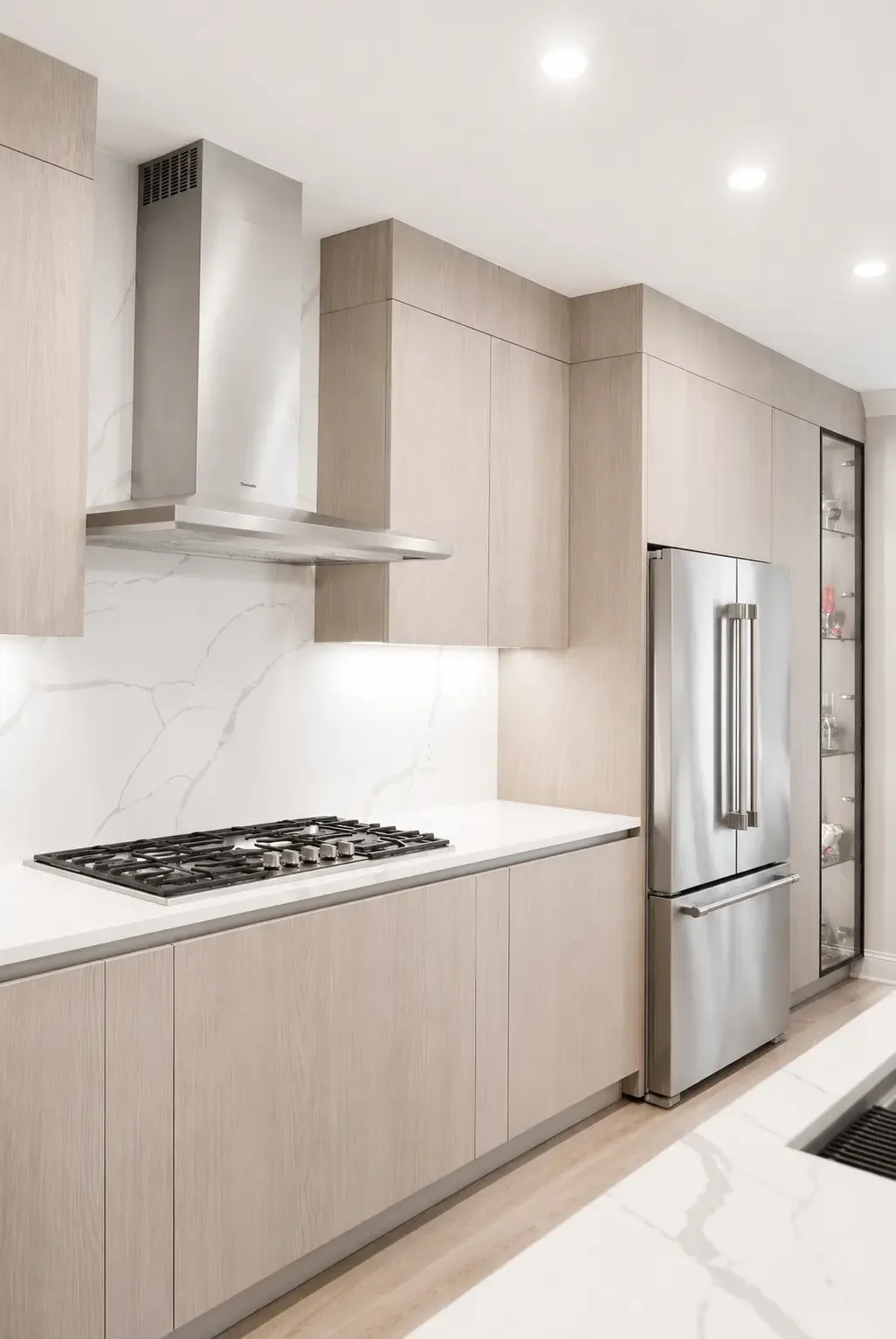 Transitional kitchen hood wall with quartz countertop, backsplash with integrated cooktop in Woodland Park NJ.