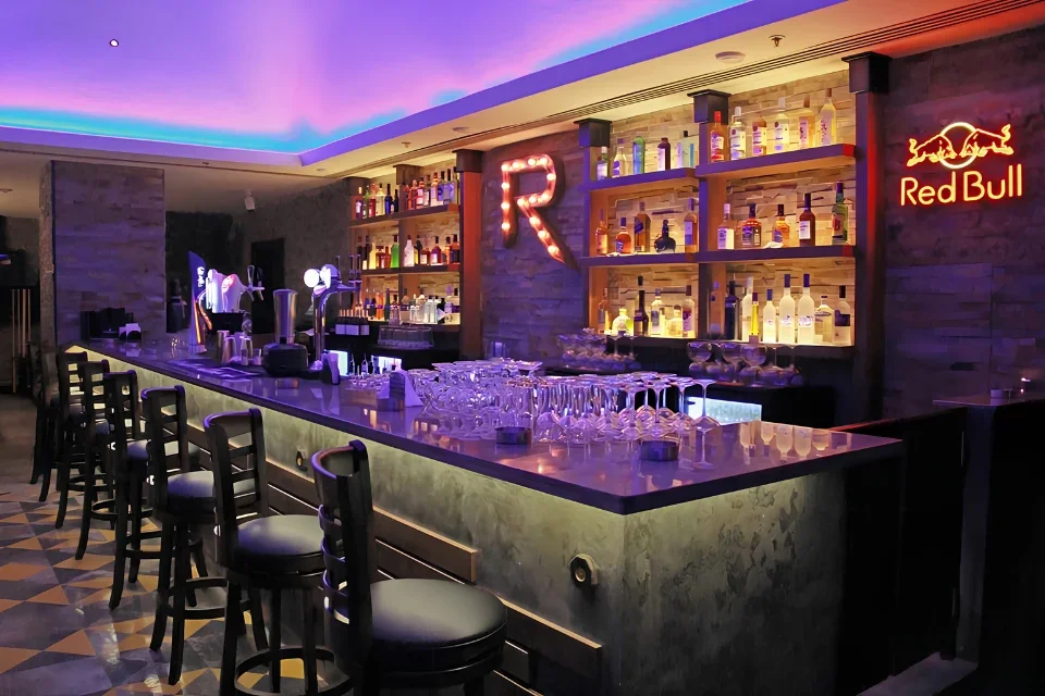 Retox bar and lounge interior design in Holiday Inn Al Barsha Dubai with illuminated bar, graffiti artwork, and ambient lighting