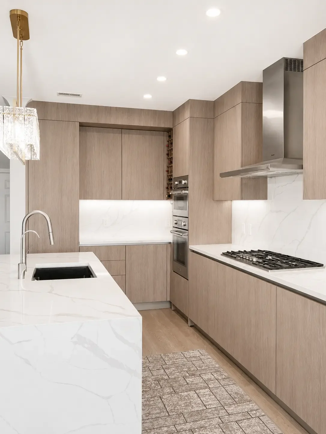 Italian custom cabinetry in a combination of veneer slab doors with metal laminates cabinets for the island in this transitional Woodland Park NJ kitchen design.