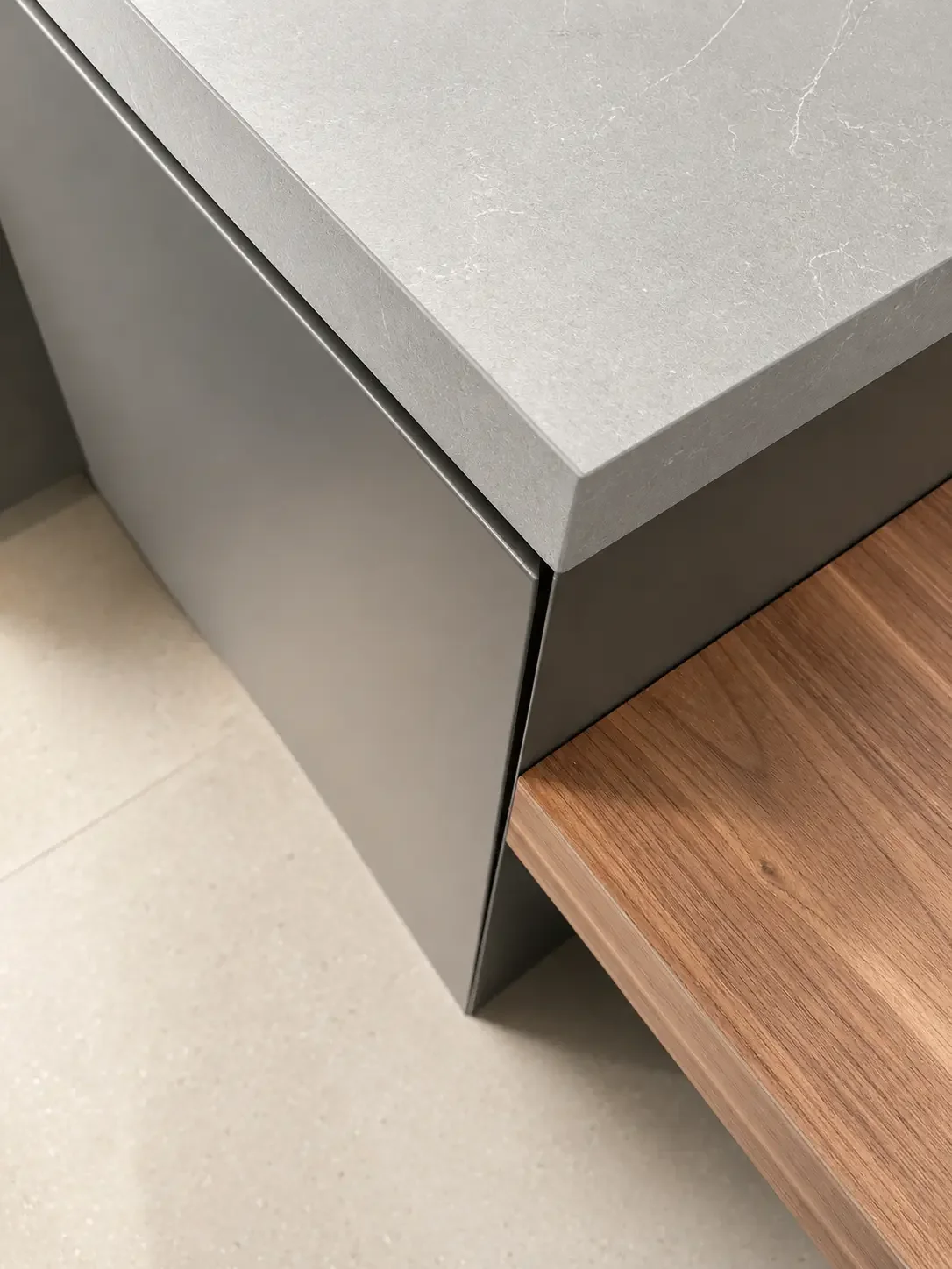 Walnut wood Breakfast table detail attached to the island with metal finish and push to open cabinetry in this Franklin Lakes NJ kitchen.