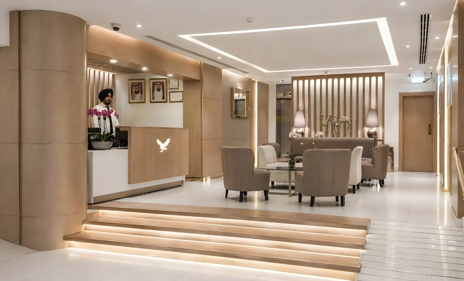 Hotel lobby renovation at Royal Falcon Hotel in Bur Dubai featuring warm neutral tones, layered lighting, and contemporary seating design