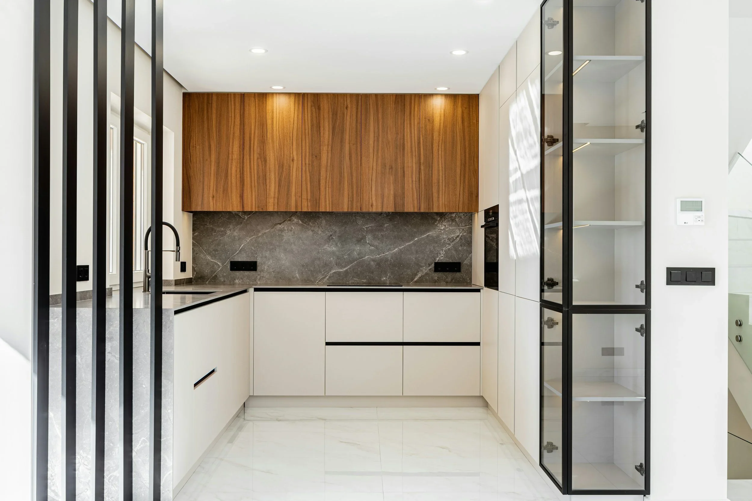 Contemporary white kitches with upper cabinets in wood finish