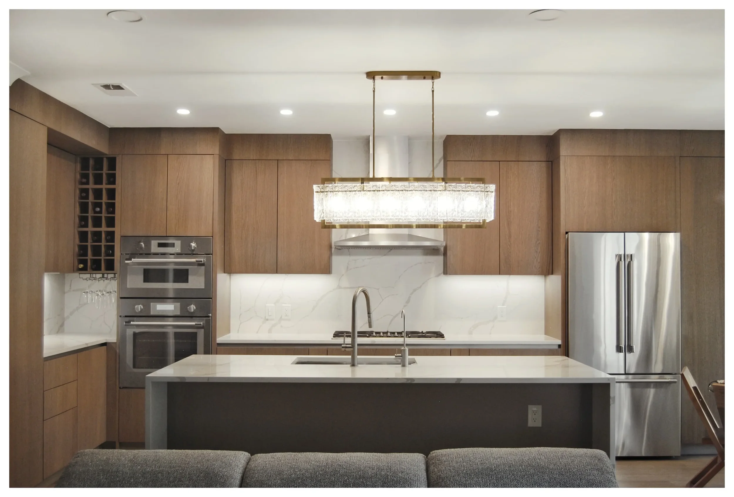 Transitional kitchen design in Woodland Park NJ with wood cabinetry and integrated appliances