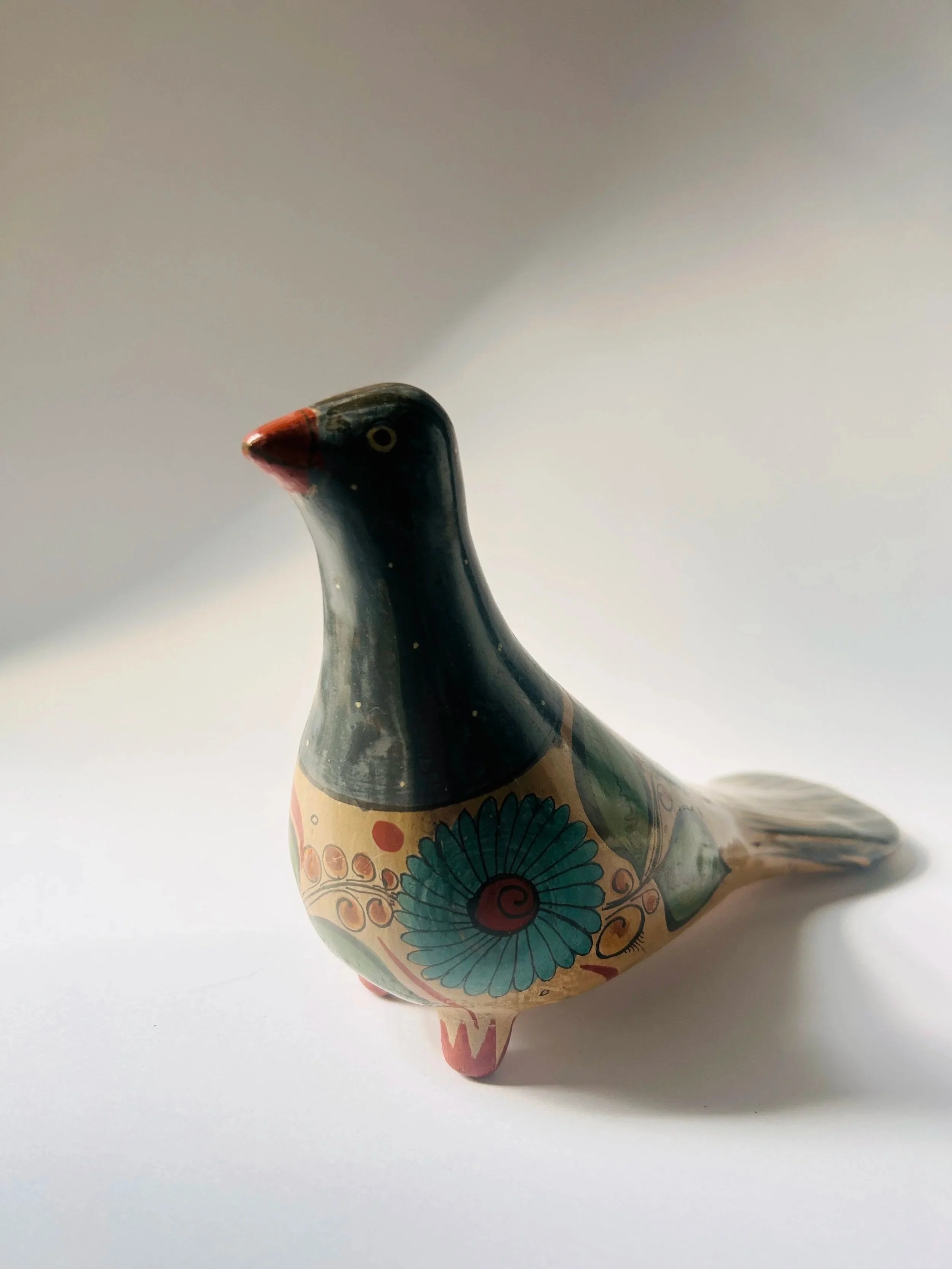 Vintage hand-painted ceramic bird figurine with Mexican floral folk art design, decorative Tonala dove sculpture