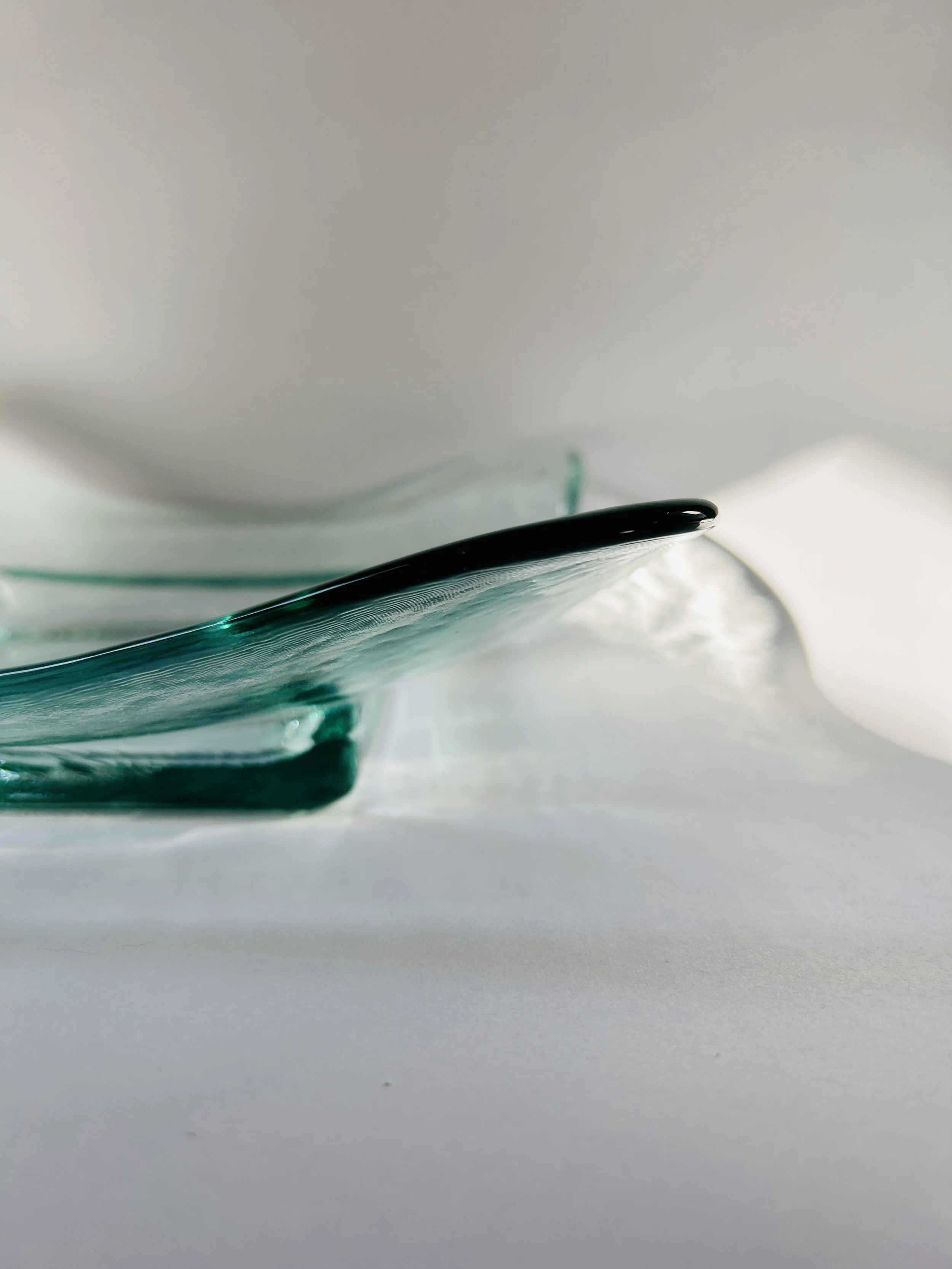 Contemporary Spanish recycled glass bowl with wavy edges and soft aqua tint, modern sculptural serving dish