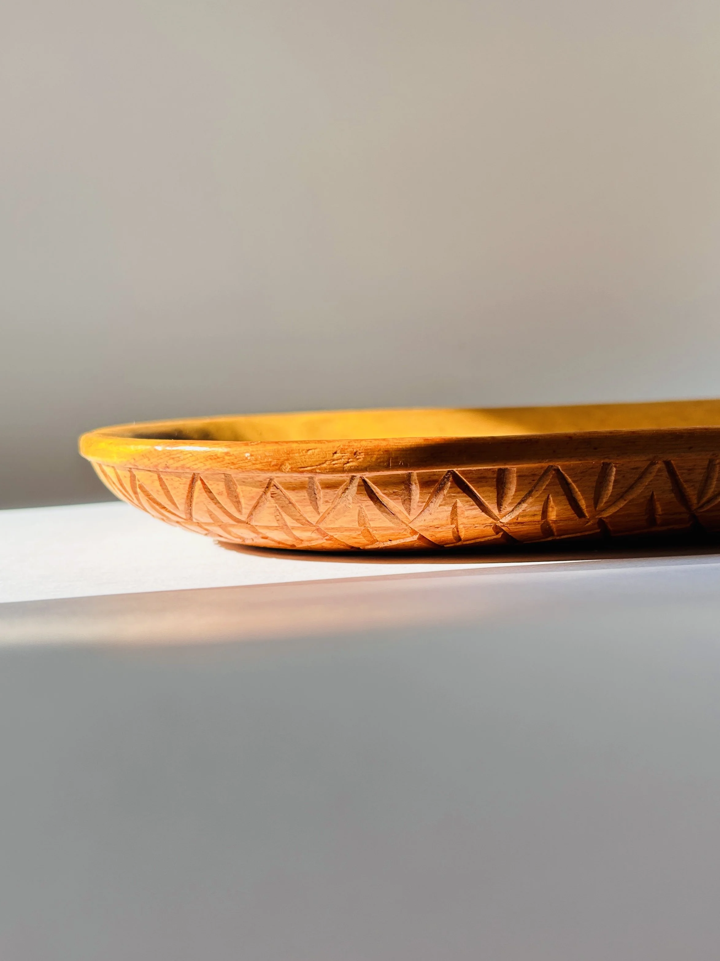 Primitive hand-carved wooden tray with organic shape and warm patina, rustic serving board