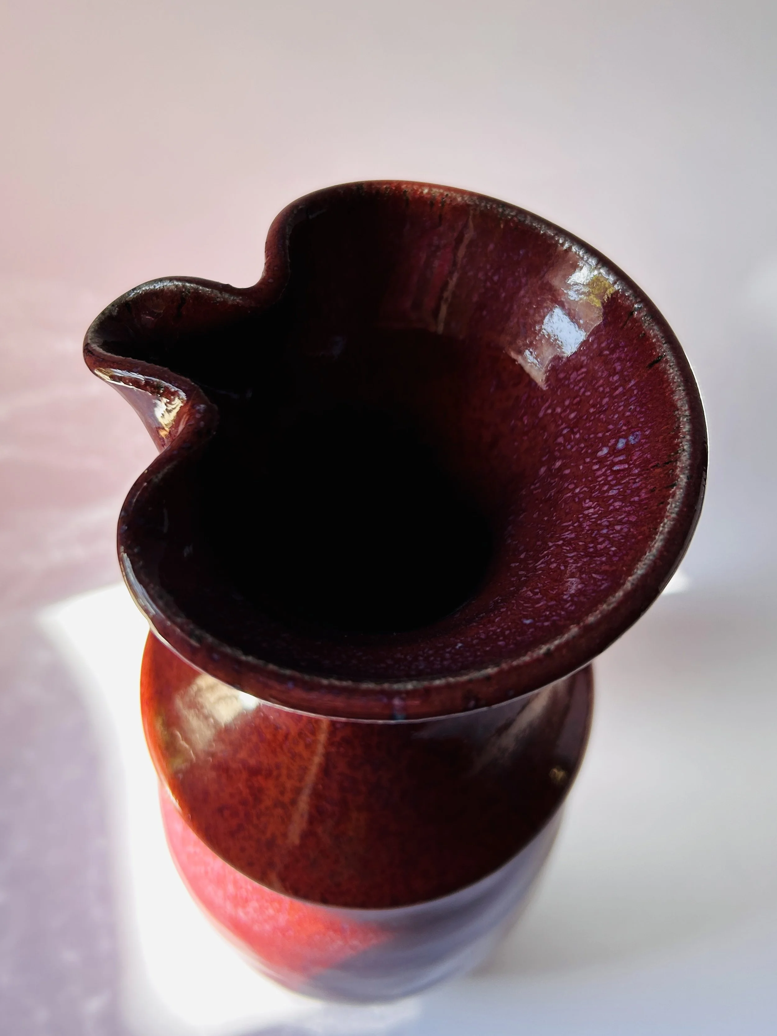 red and purple studio pottery decanter with ribbon mouth spout and textured glaze