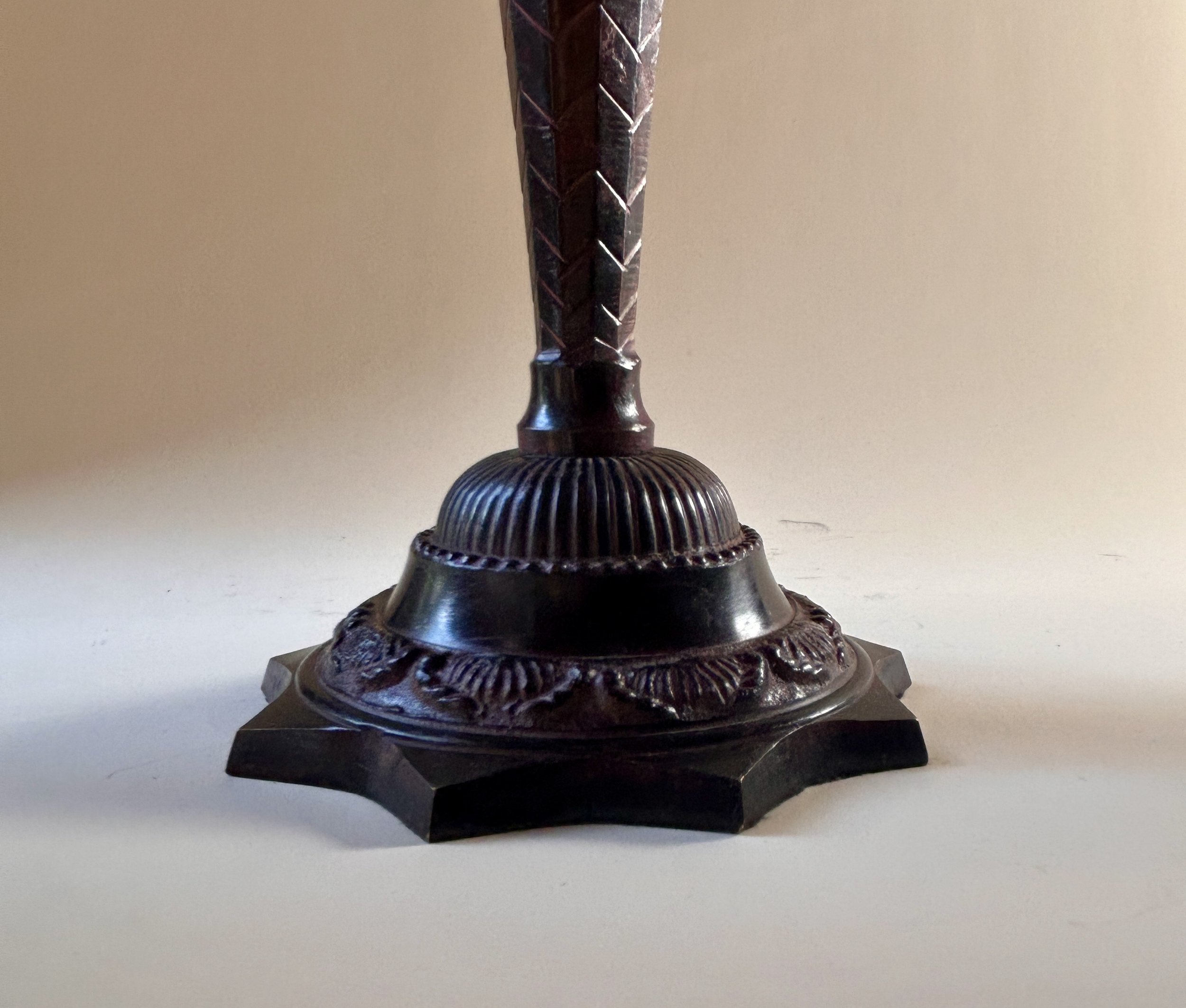 Pair of tall vintage three light candelabras with dark ornate bases, sweeping arms and sculptural green patinated palm leaf candle cups.