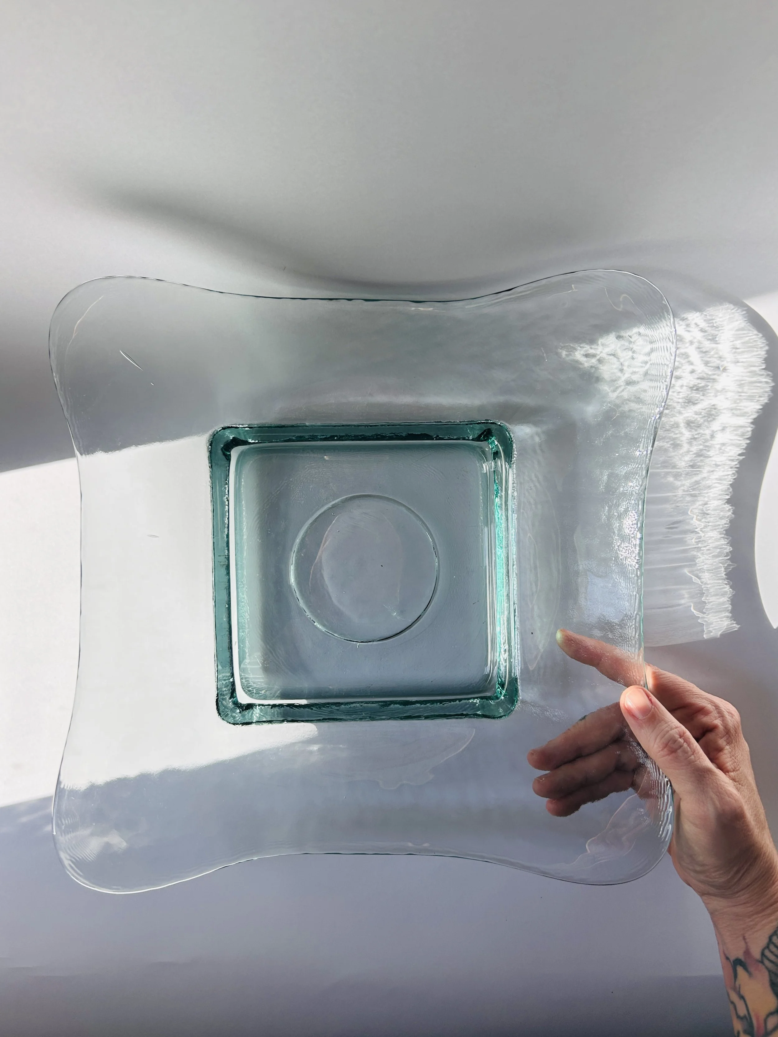 Contemporary Spanish recycled glass bowl with wavy edges and soft aqua tint, modern sculptural serving dish