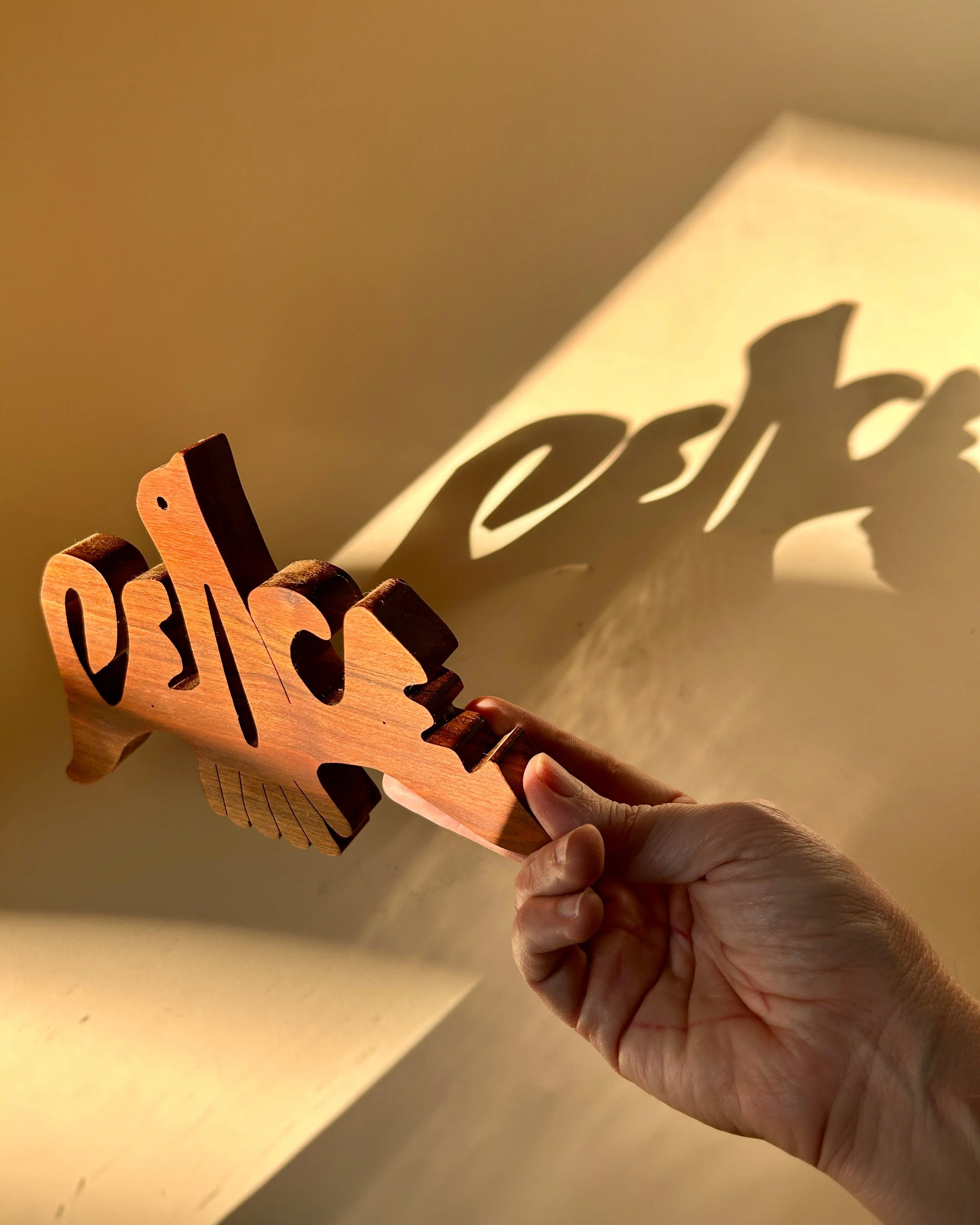 Vintage carved walnut wood Dove of Peace sculpture with abstract openwork wings and natural wood grain.