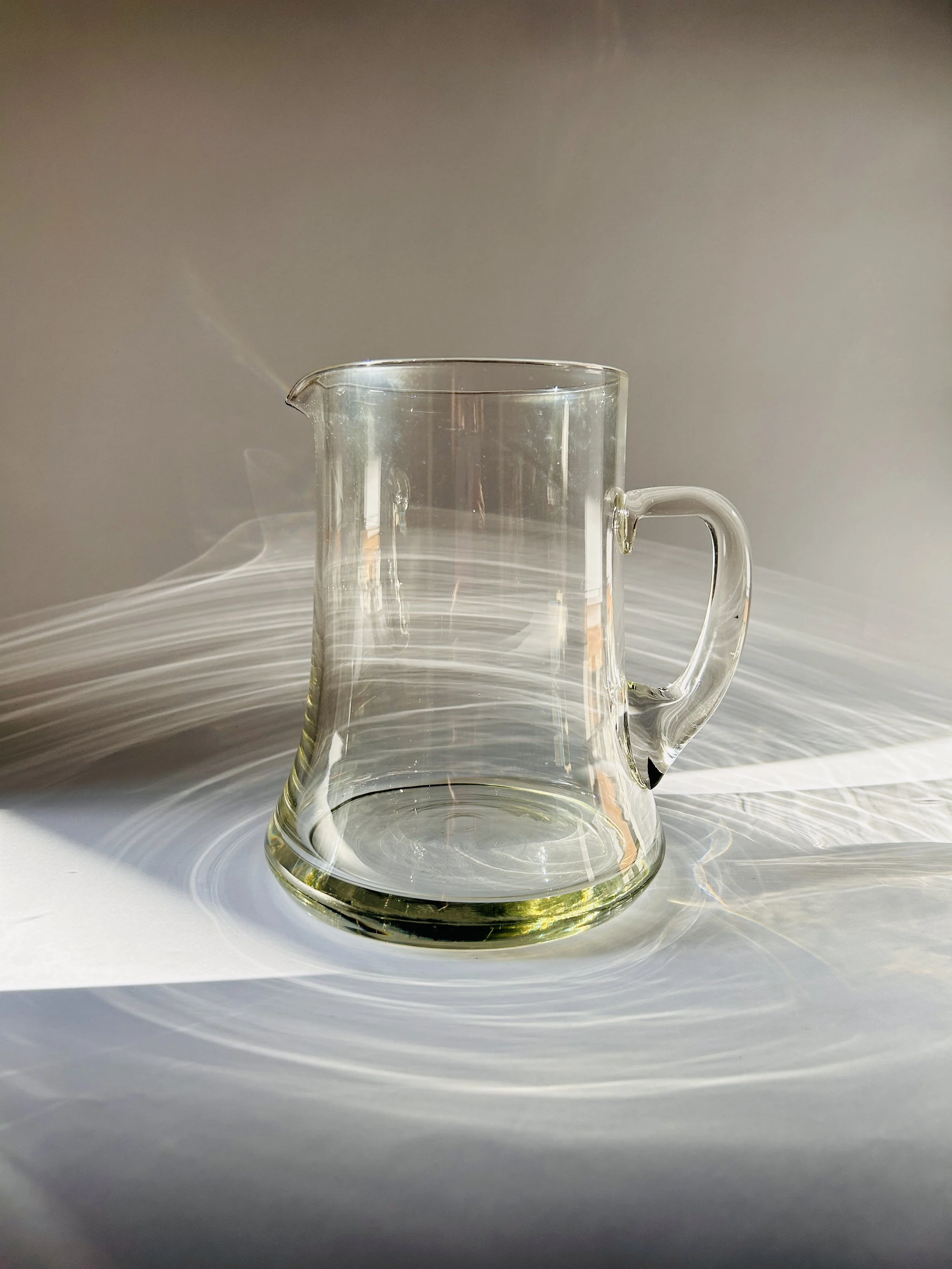clear glass pitcher with heavy base and handle, minimalist modern drink carafe