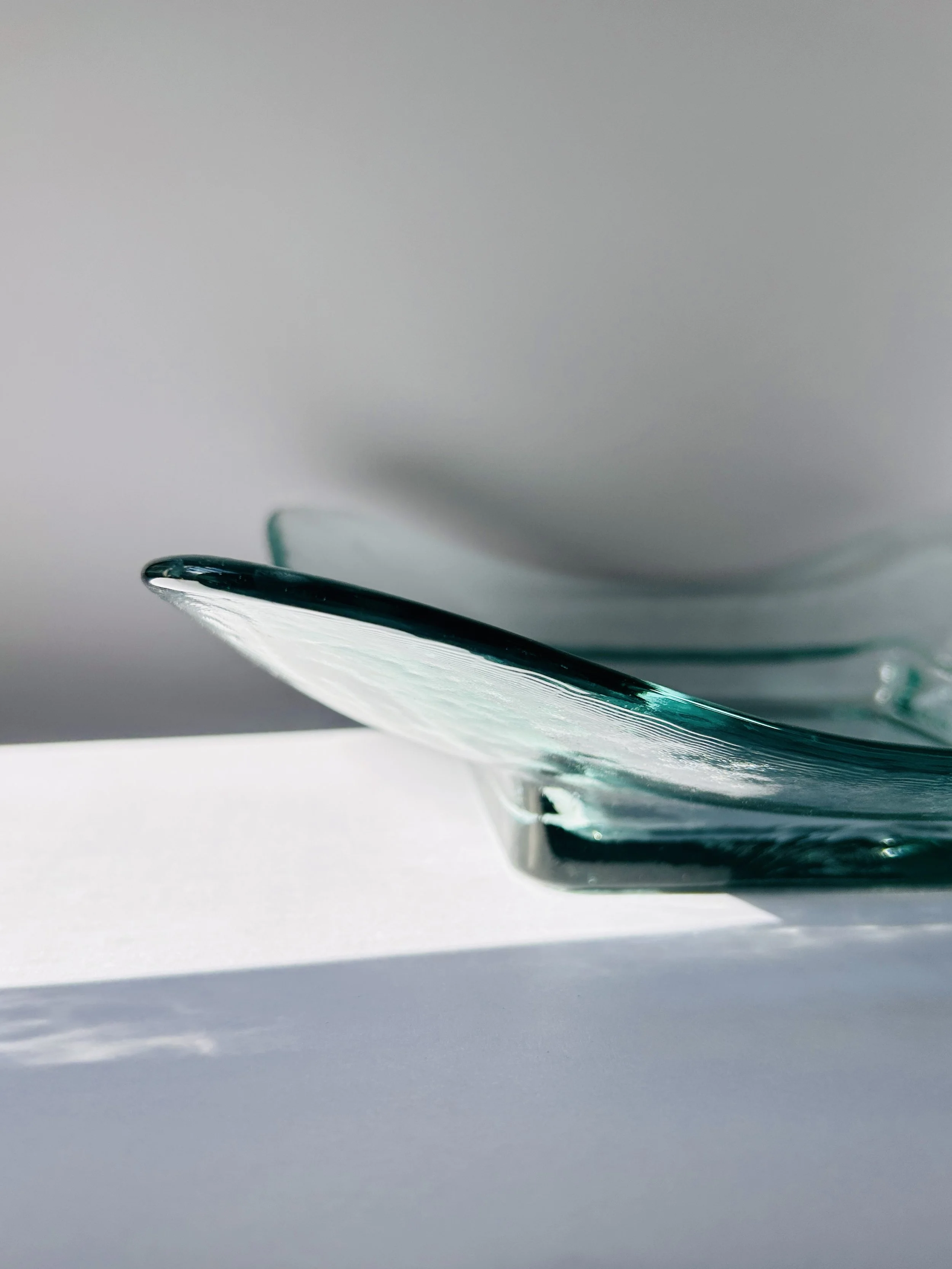 Contemporary Spanish recycled glass bowl with wavy edges and soft aqua tint, modern sculptural serving dish