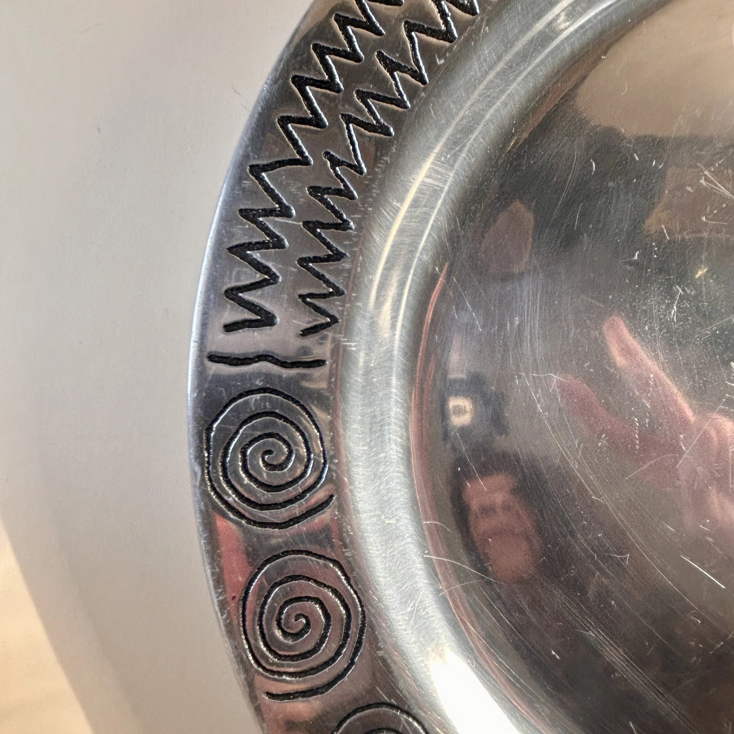 Vintage Wilton Armetale Reggae round metal platter with engraved spiral, zigzag, and geometric border.