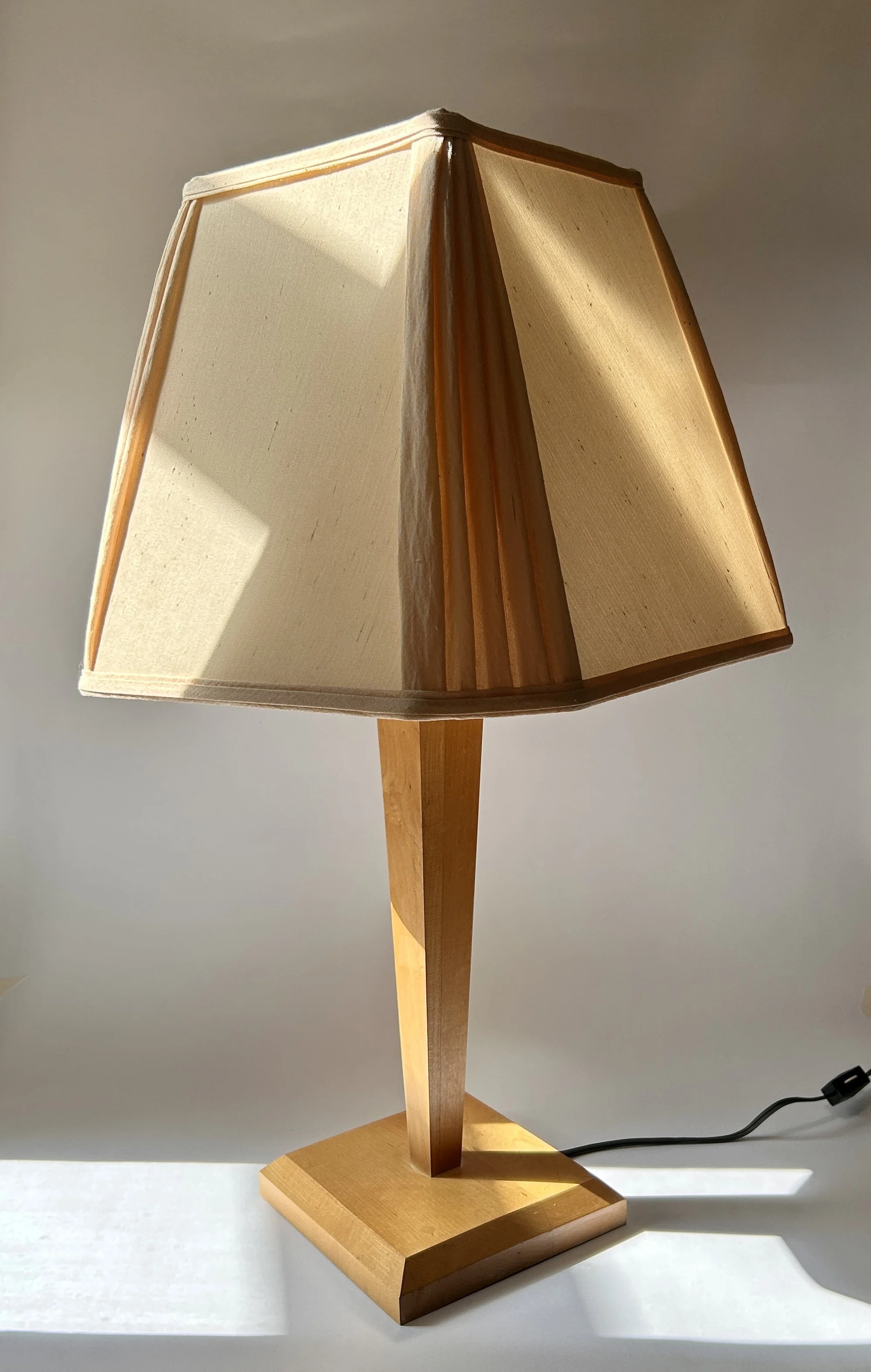 Vintage minimalist wooden table lamp with tapered geometric column, square wood base, and warm ivory raw silk shade.
