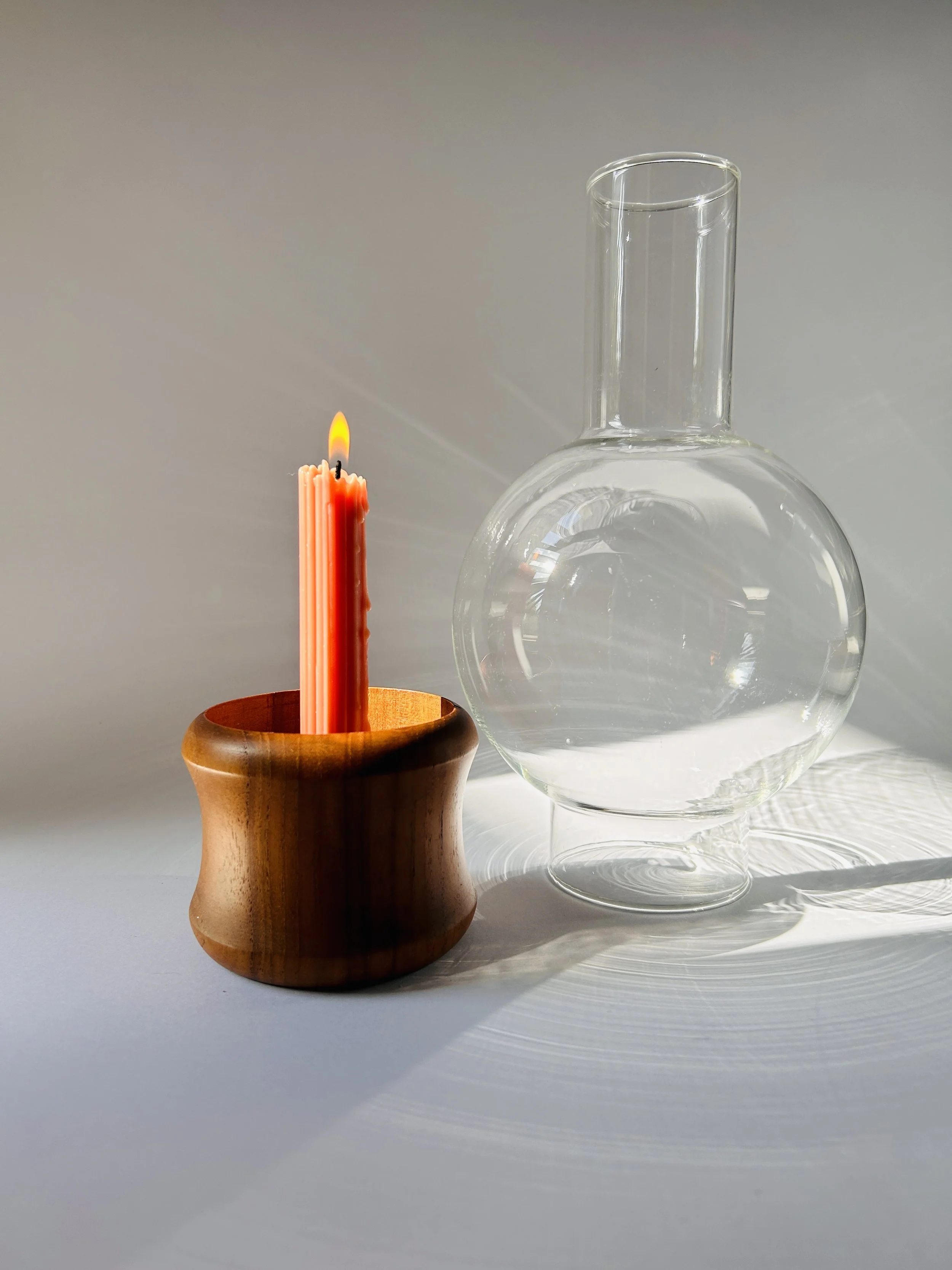 Mid-century glass hurricane candle holder with wooden base and taper candle, sculptural modern decor