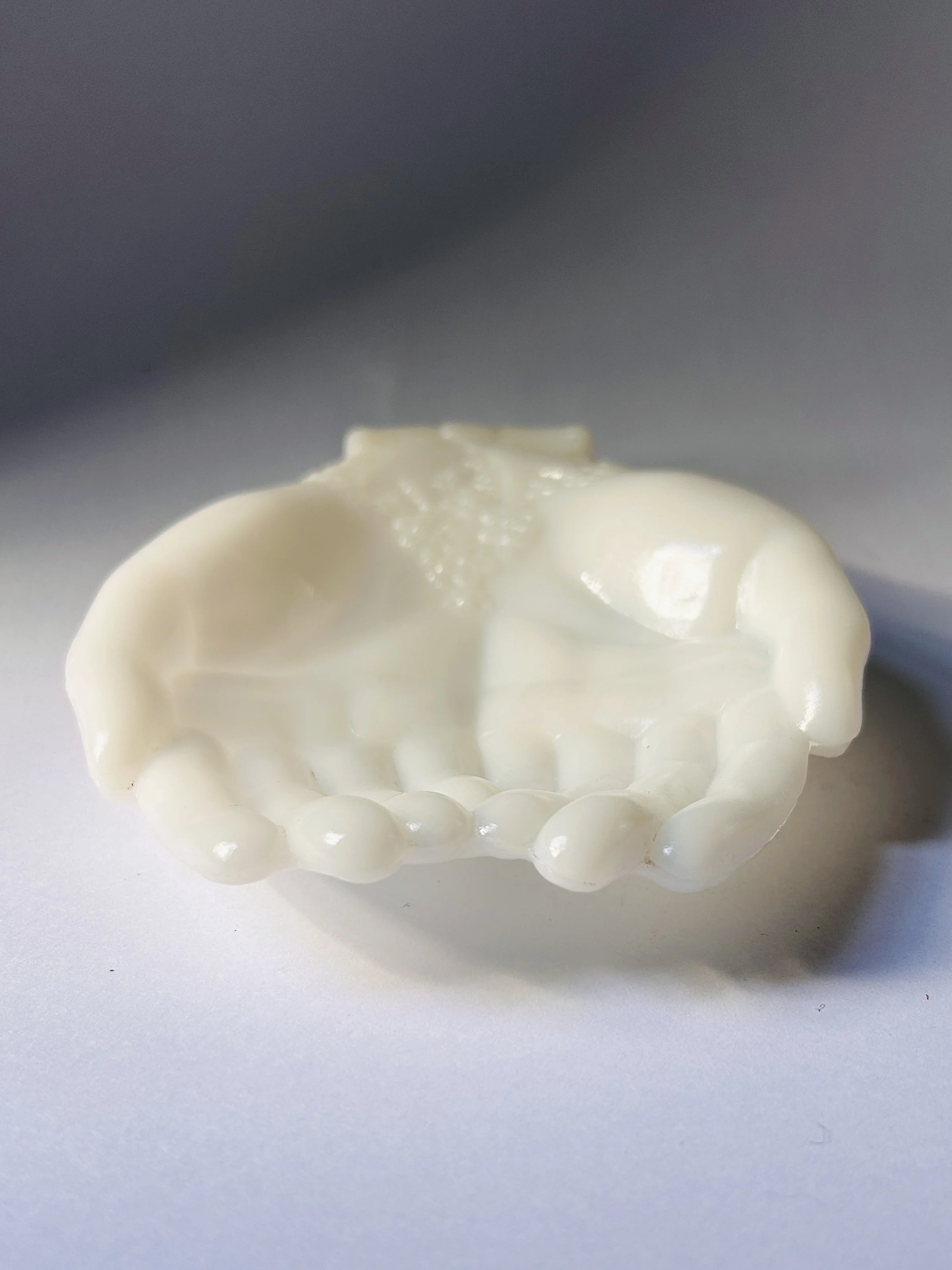 Vintage Avon milk glass sculpture of two hands holding each other, giving hands figurine in white glass