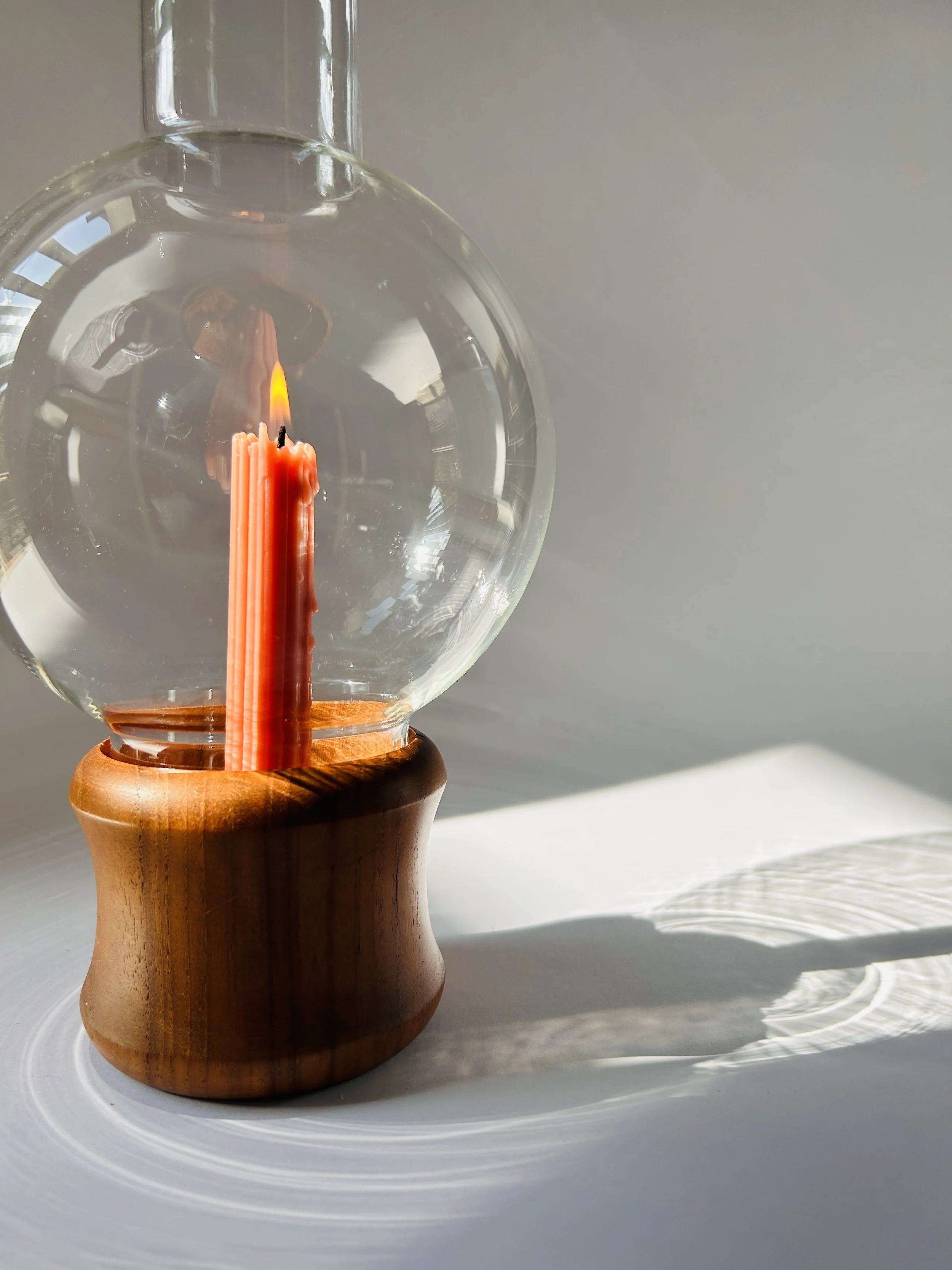 Mid-century glass hurricane candle holder with wooden base and taper candle, sculptural modern decor