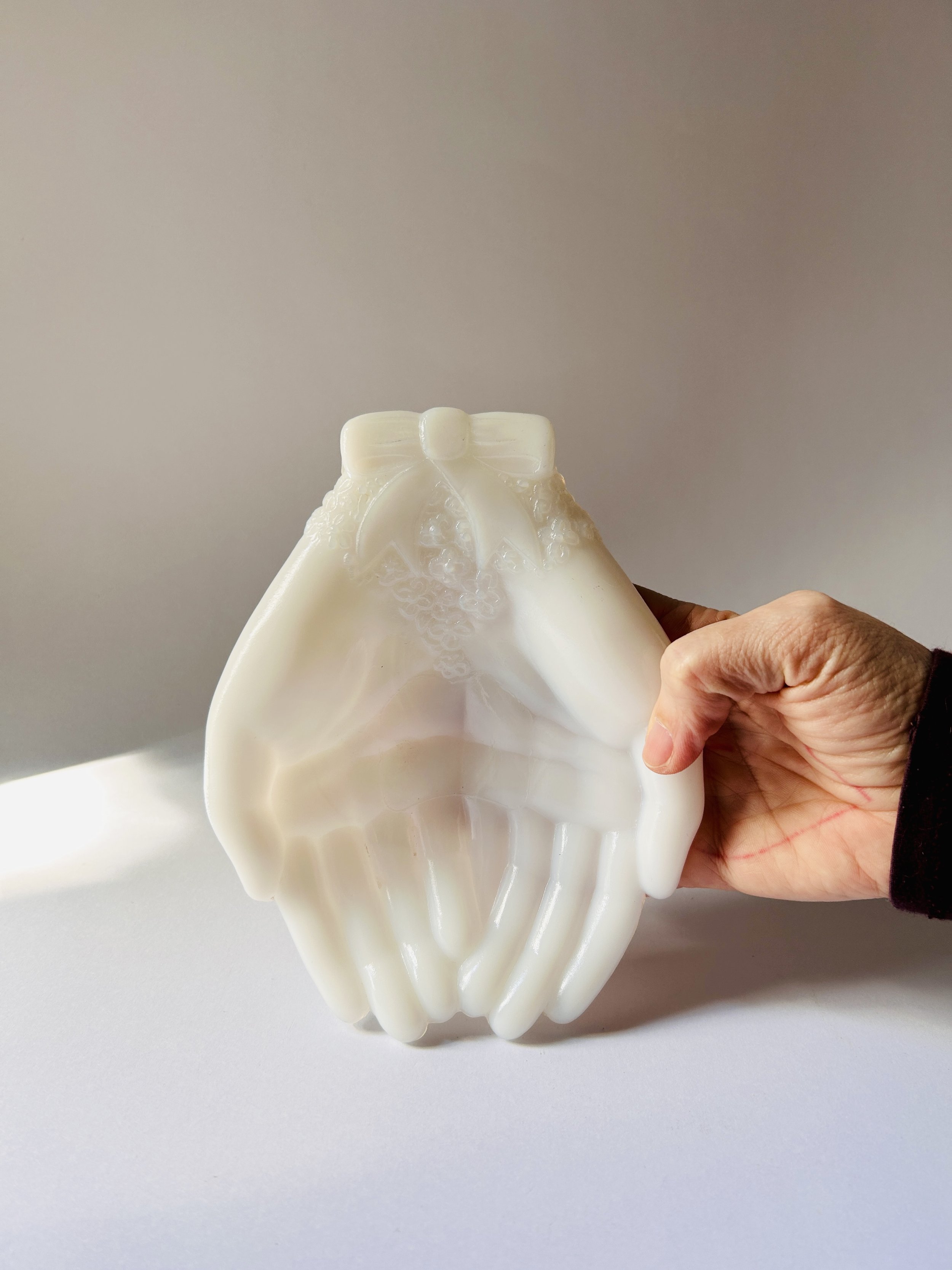 Vintage Avon milk glass sculpture of two hands holding each other, giving hands figurine in white glass