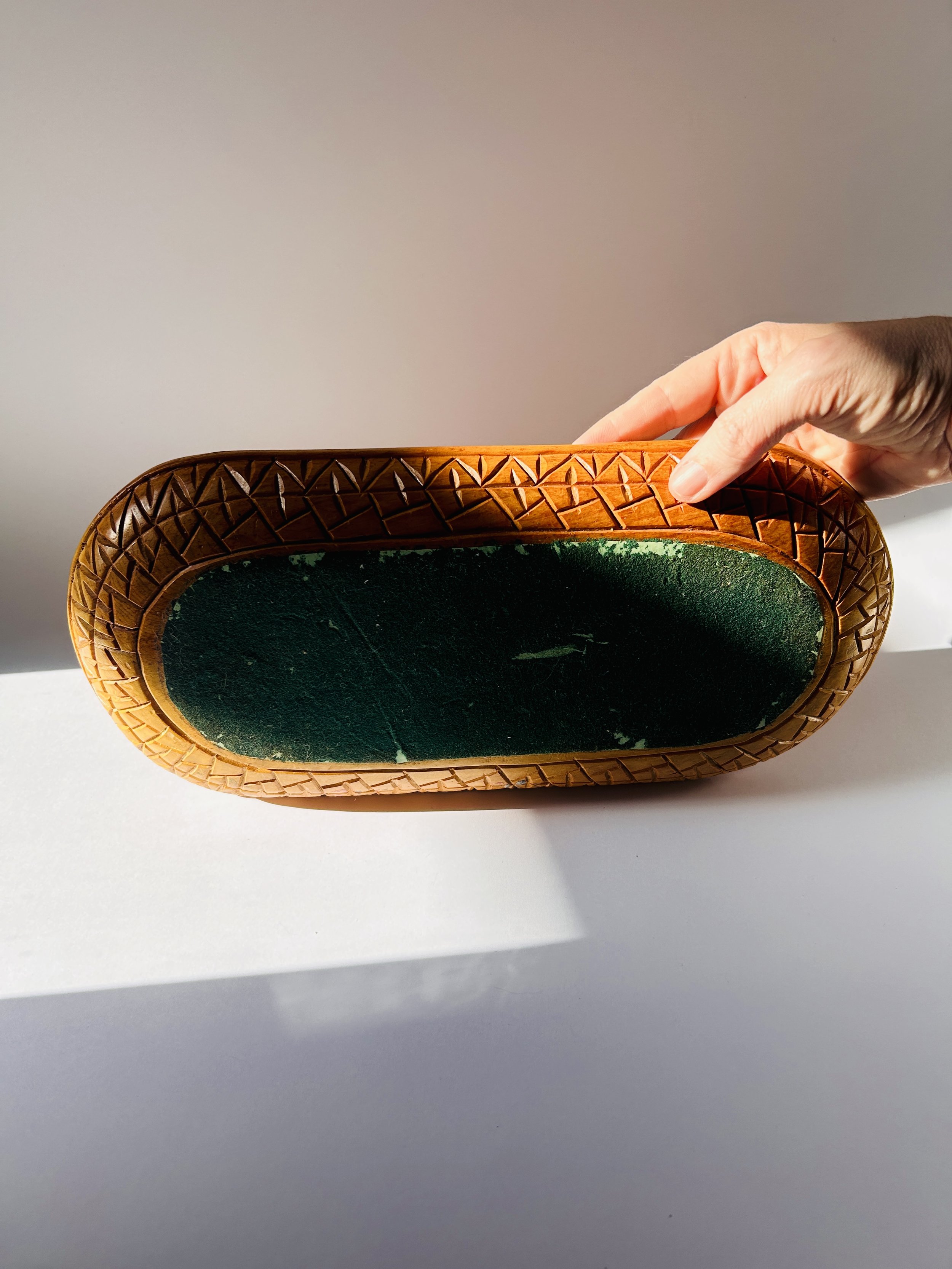 Primitive hand-carved wooden tray with organic shape and warm patina, rustic serving board