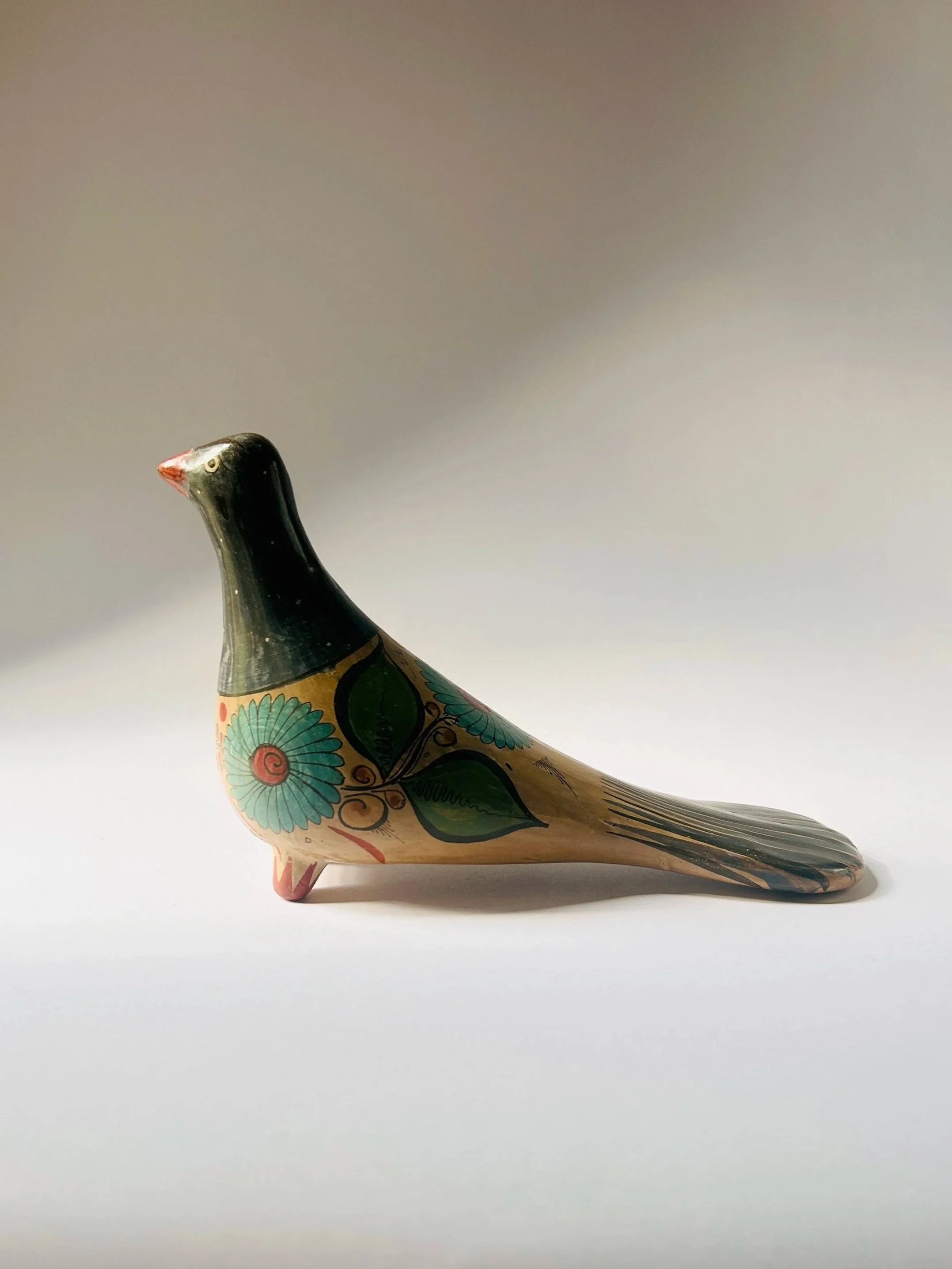 Vintage hand-painted ceramic bird figurine with Mexican floral folk art design, decorative Tonala dove sculpture