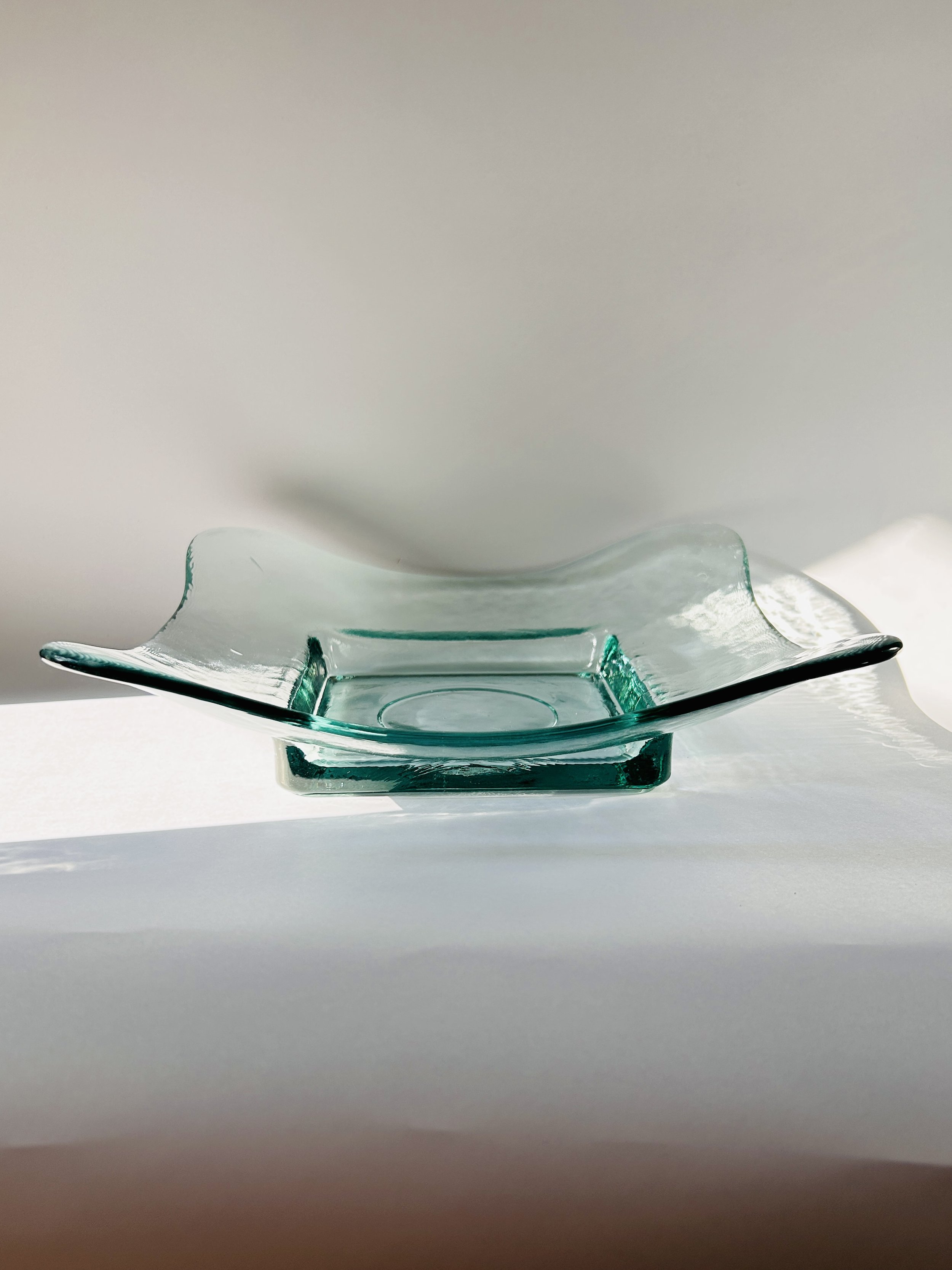 Contemporary Spanish recycled glass bowl with wavy edges and soft aqua tint, modern sculptural serving dish