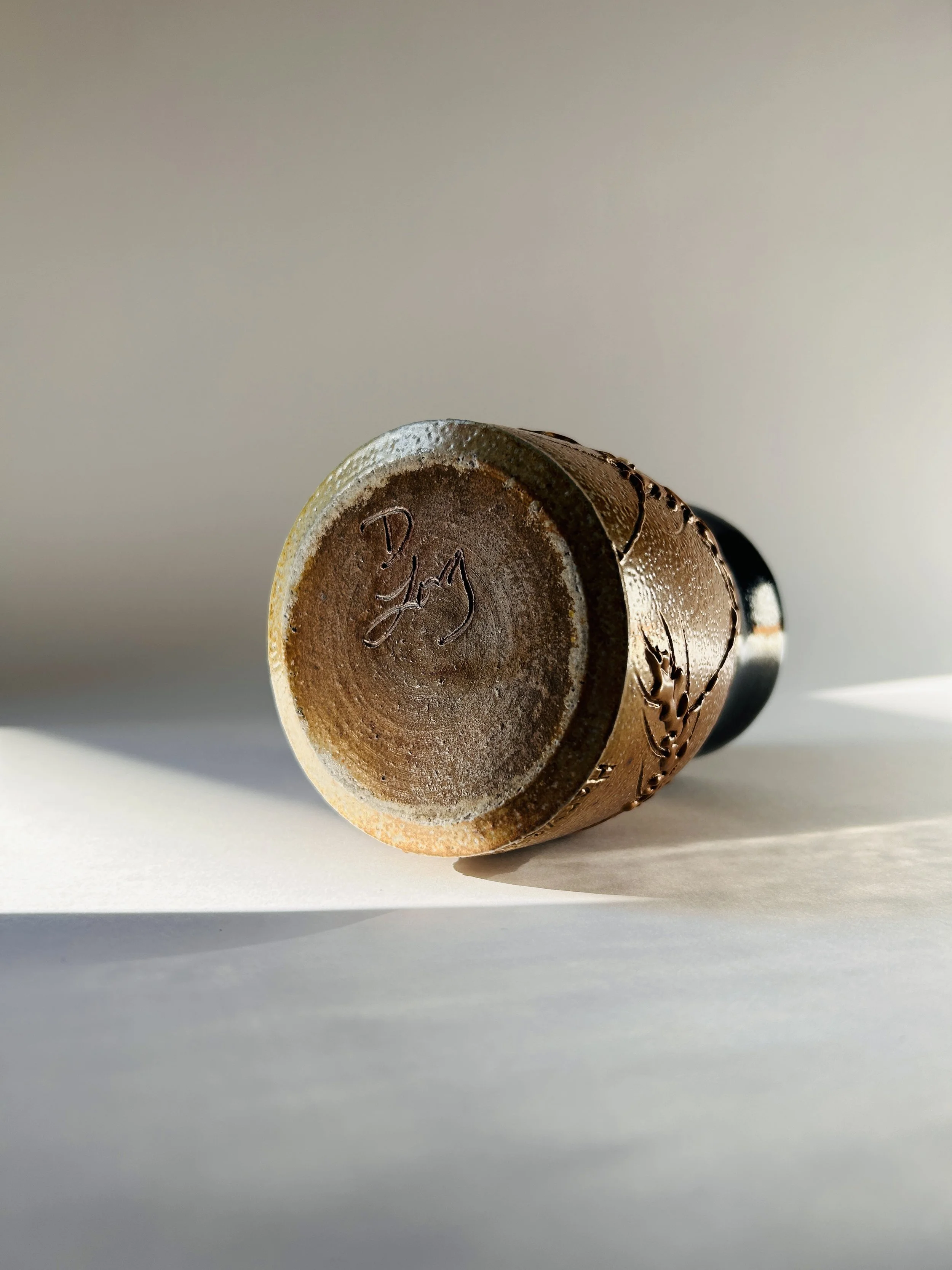 handmade ceramic mug with embossed wheat design and brown to blue glaze