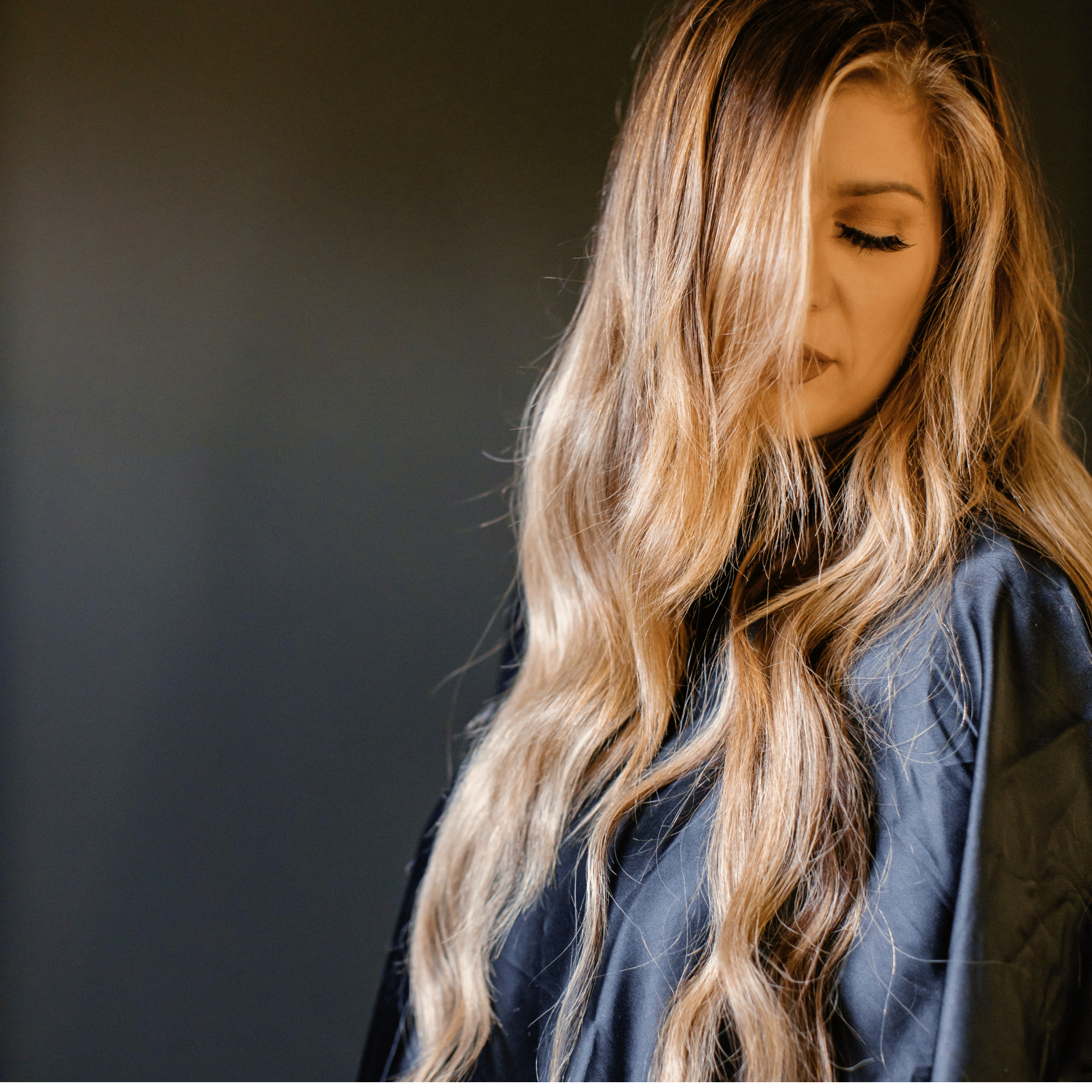 Luxury blonde hair extensions with long, seamless waves at GROW Hair Lounge in Atlanta.