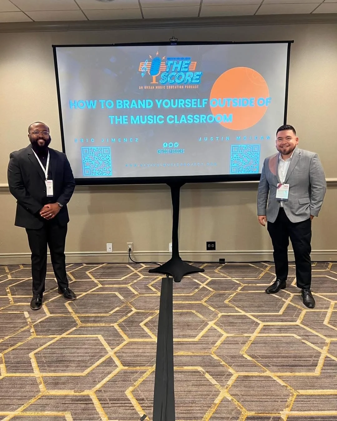 Two men standing in front of a presentation screen at a conference or seminar, titled "How to Brand Yourself Outside of the Music Classroom." The screen displays the names Eric Jimenez and Justin McLean, along with QR codes, social media handles, and a website URL.
