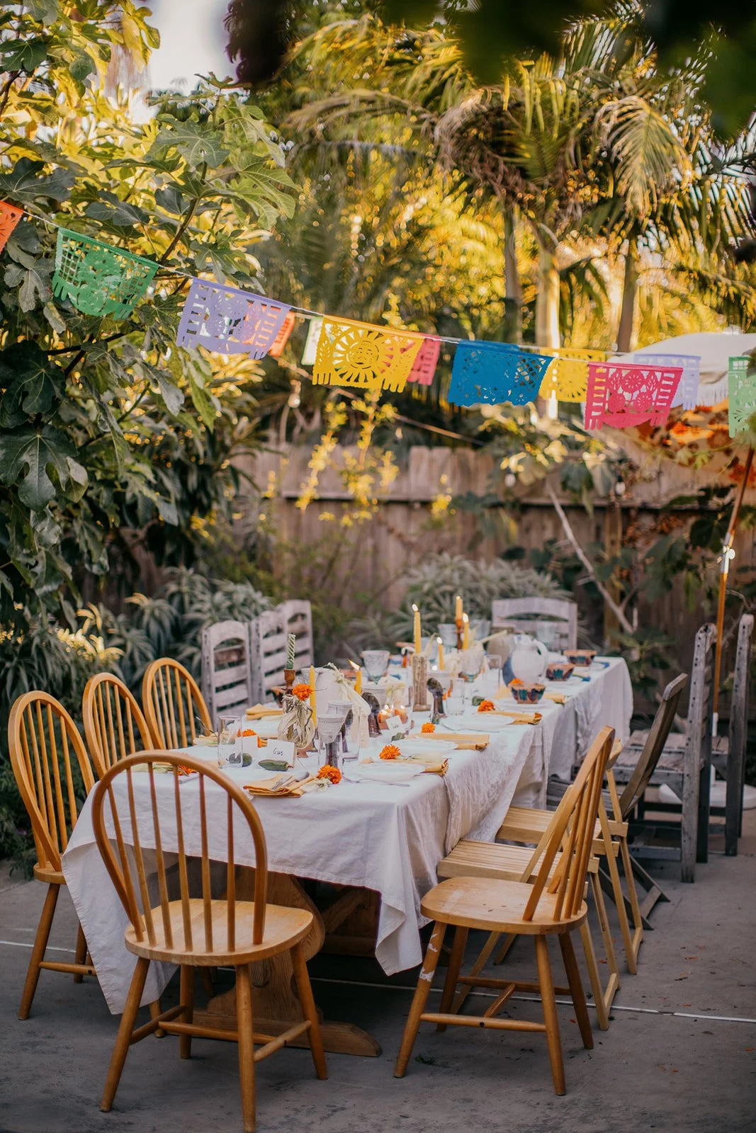 A festive outdoor dinner setup with a long table