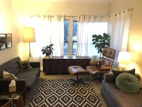 Gray couch and brown chair in Vanessa Wolter San Francisco therapy office