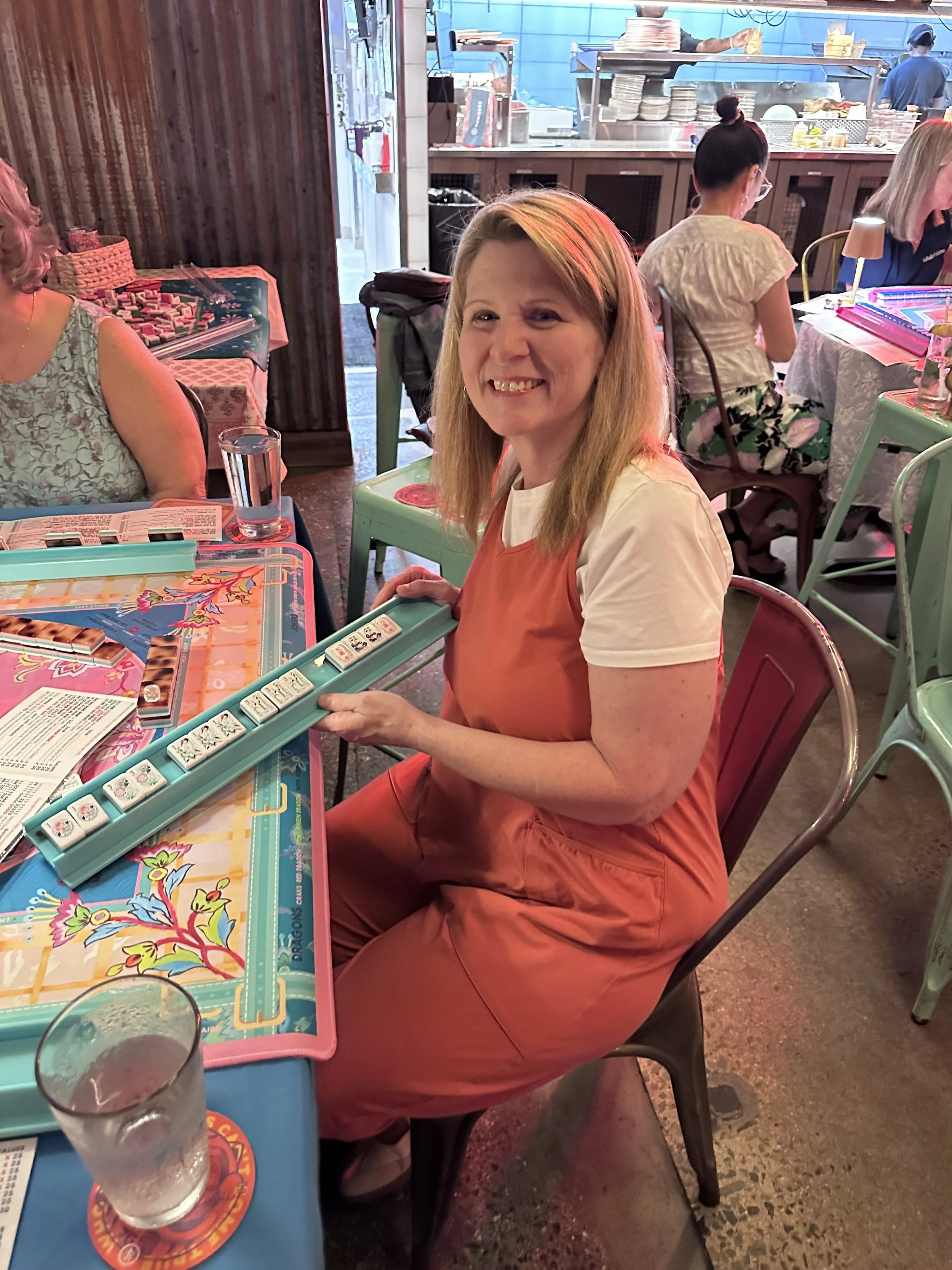 Smiling player at an American Mahjong open play in Pittsboro