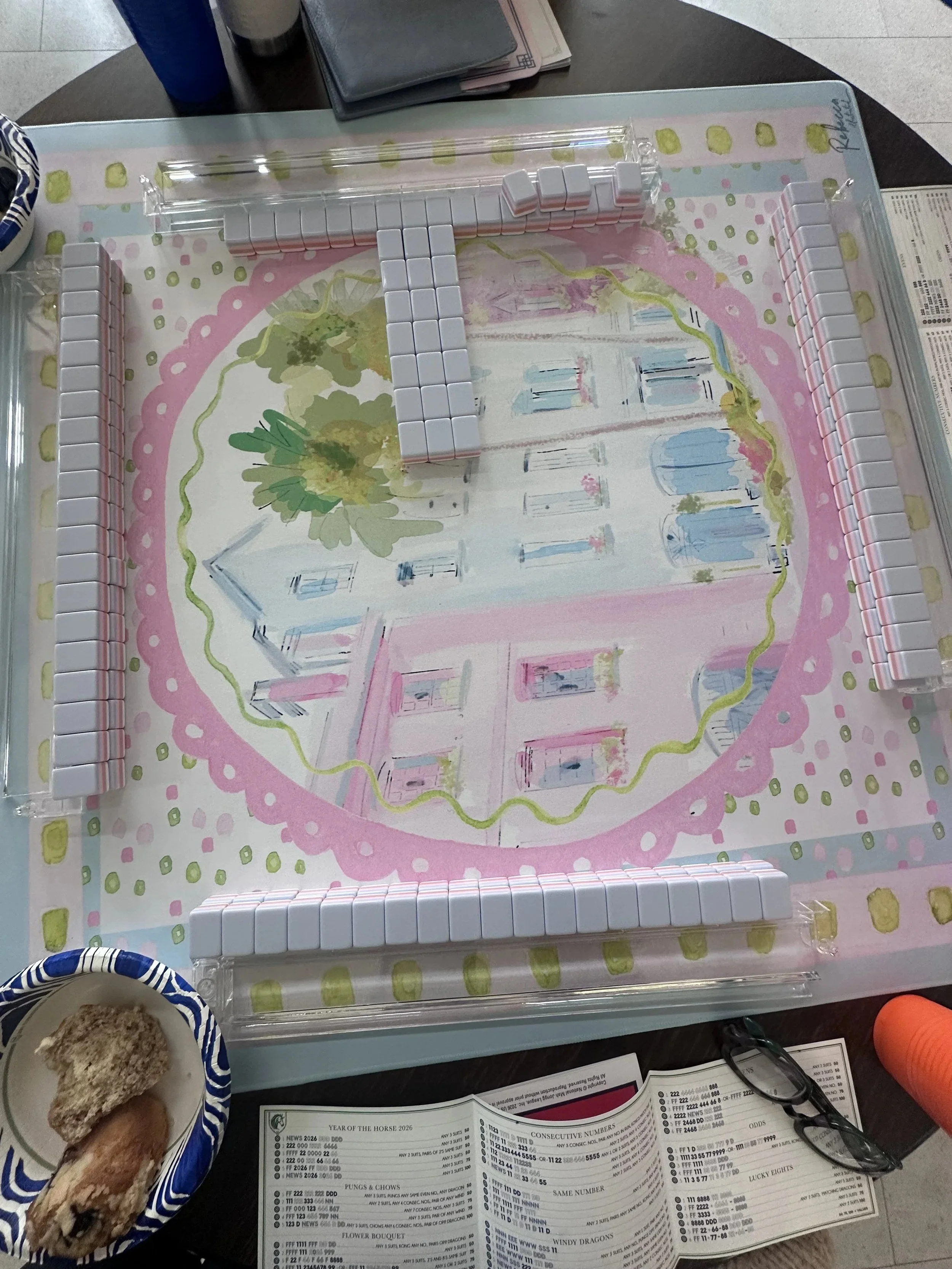 American Mahjong tiles and racks on a pastel floral Mahjong mat