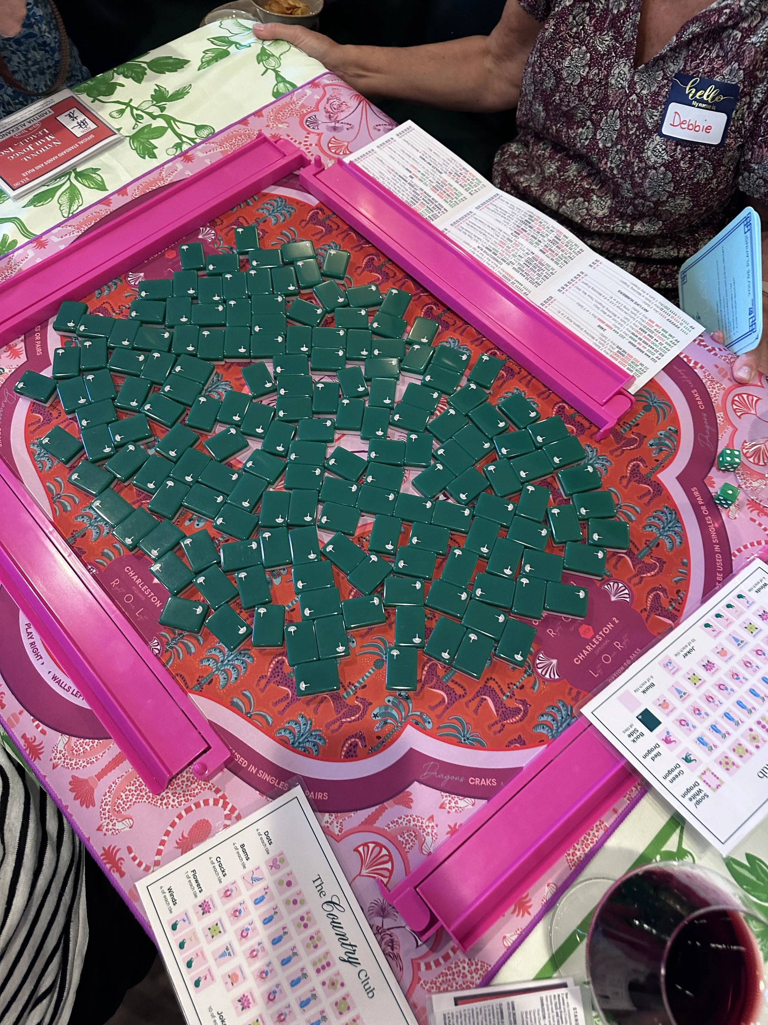 Green American Mahjong tiles on a pink and red Mahjong mat