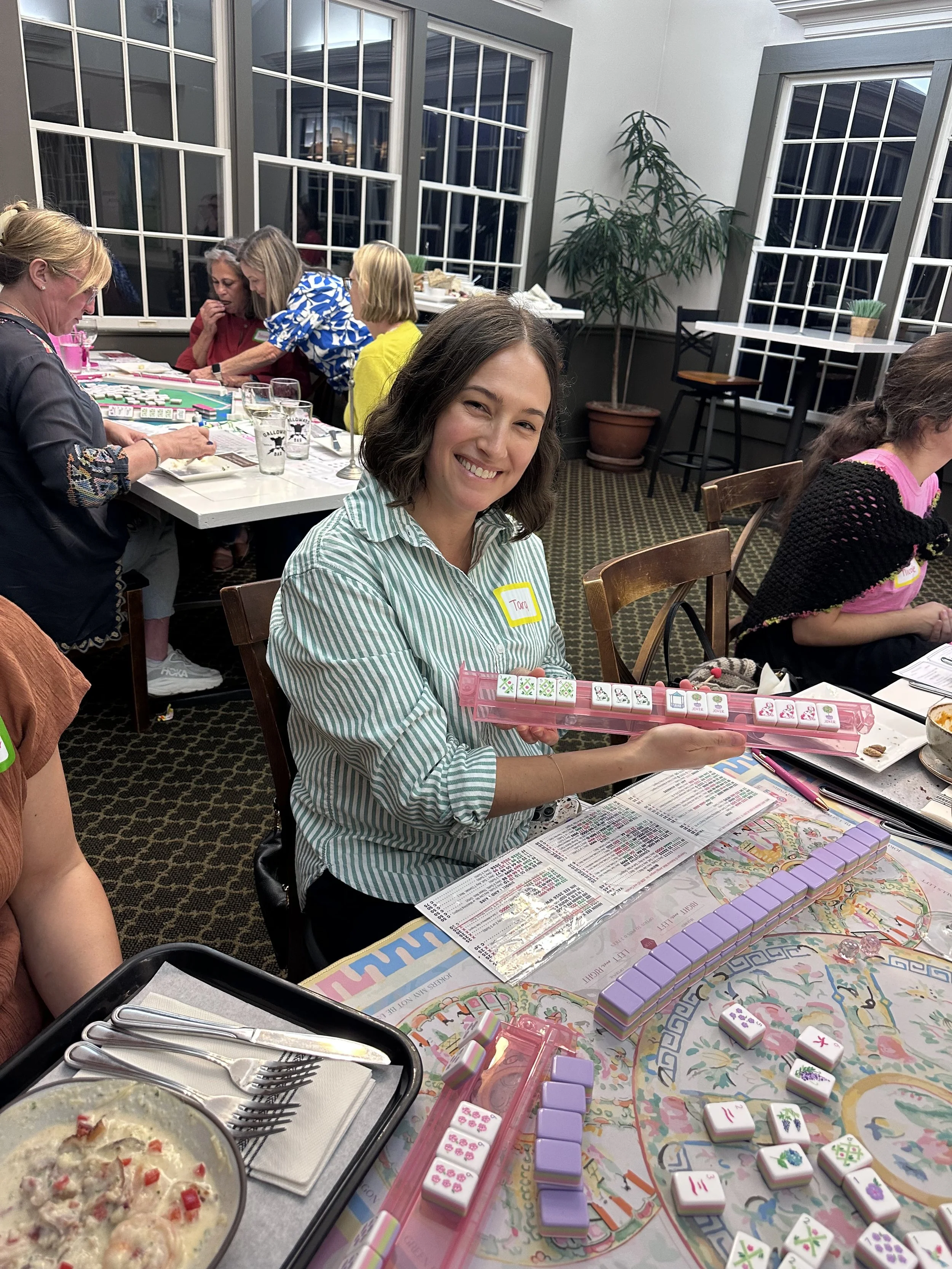 Player smiling at an American Mahjong class in Chapel Hill